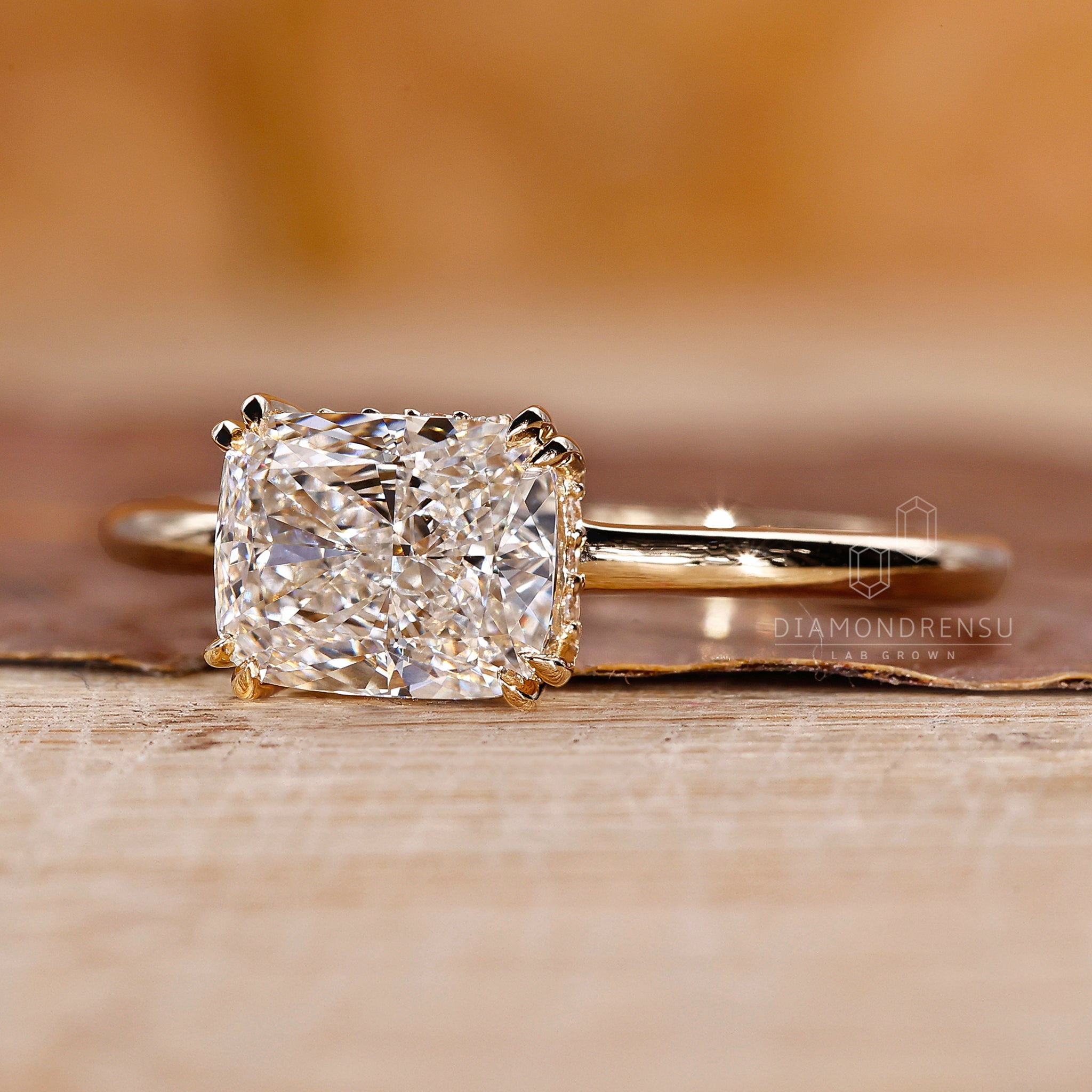 Yellow gold diamond ring with hidden halo and claw prong details.
