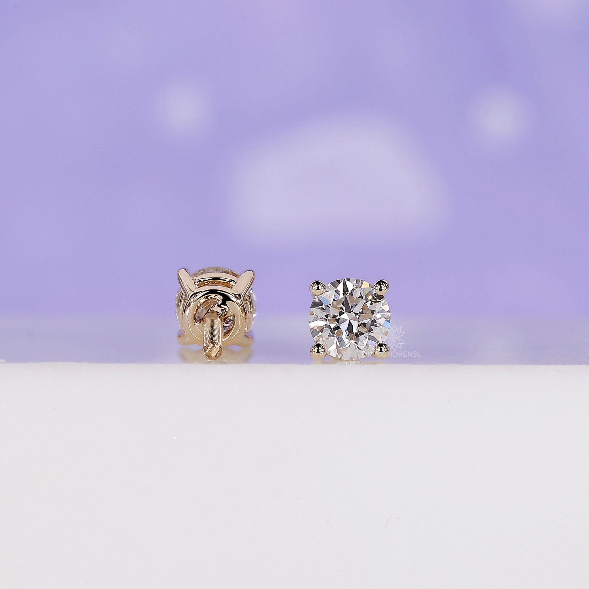 Round diamond earrings with a secure prong setting and handmade finish.