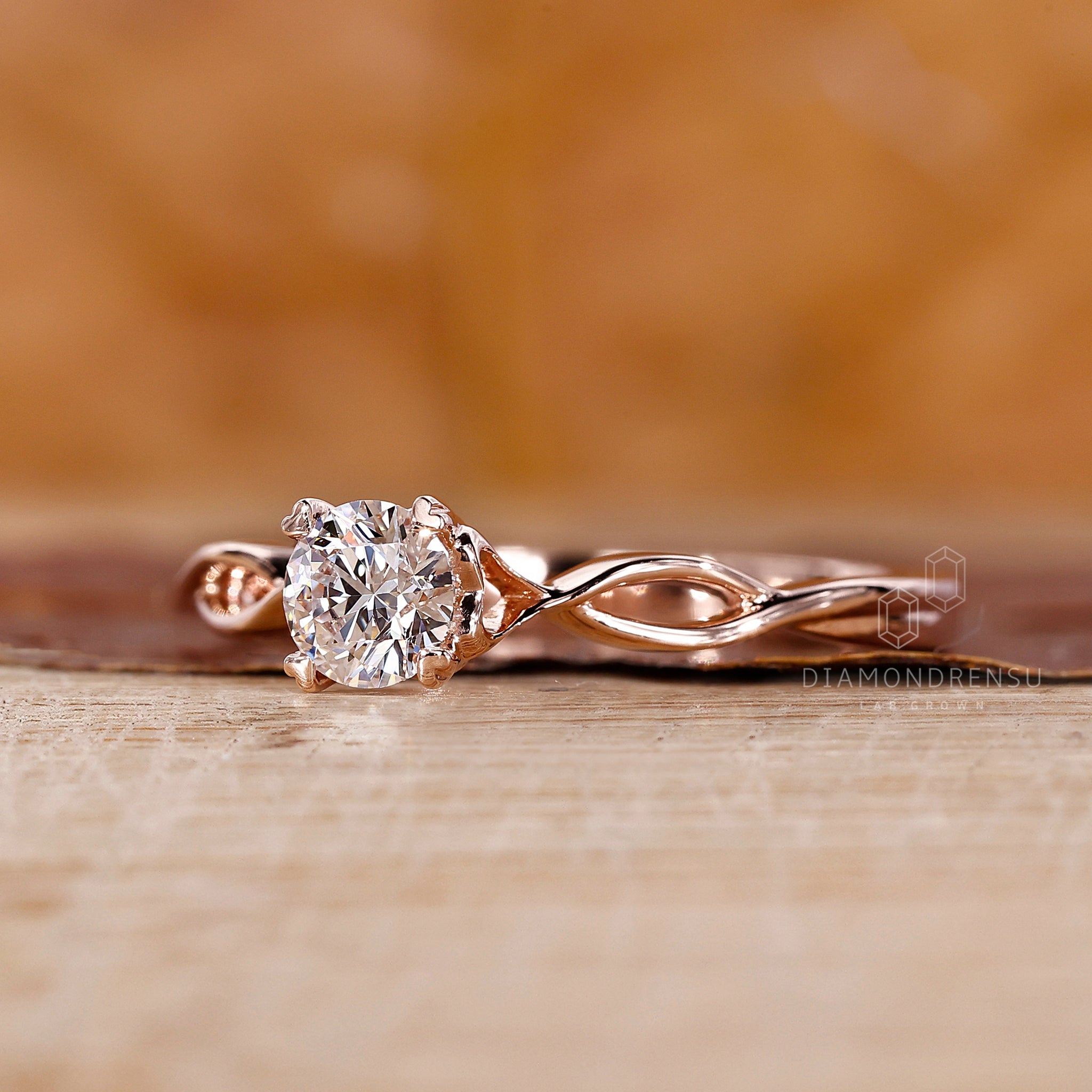 Custom engagement ring featuring round diamond solitaire and twisted shank.
