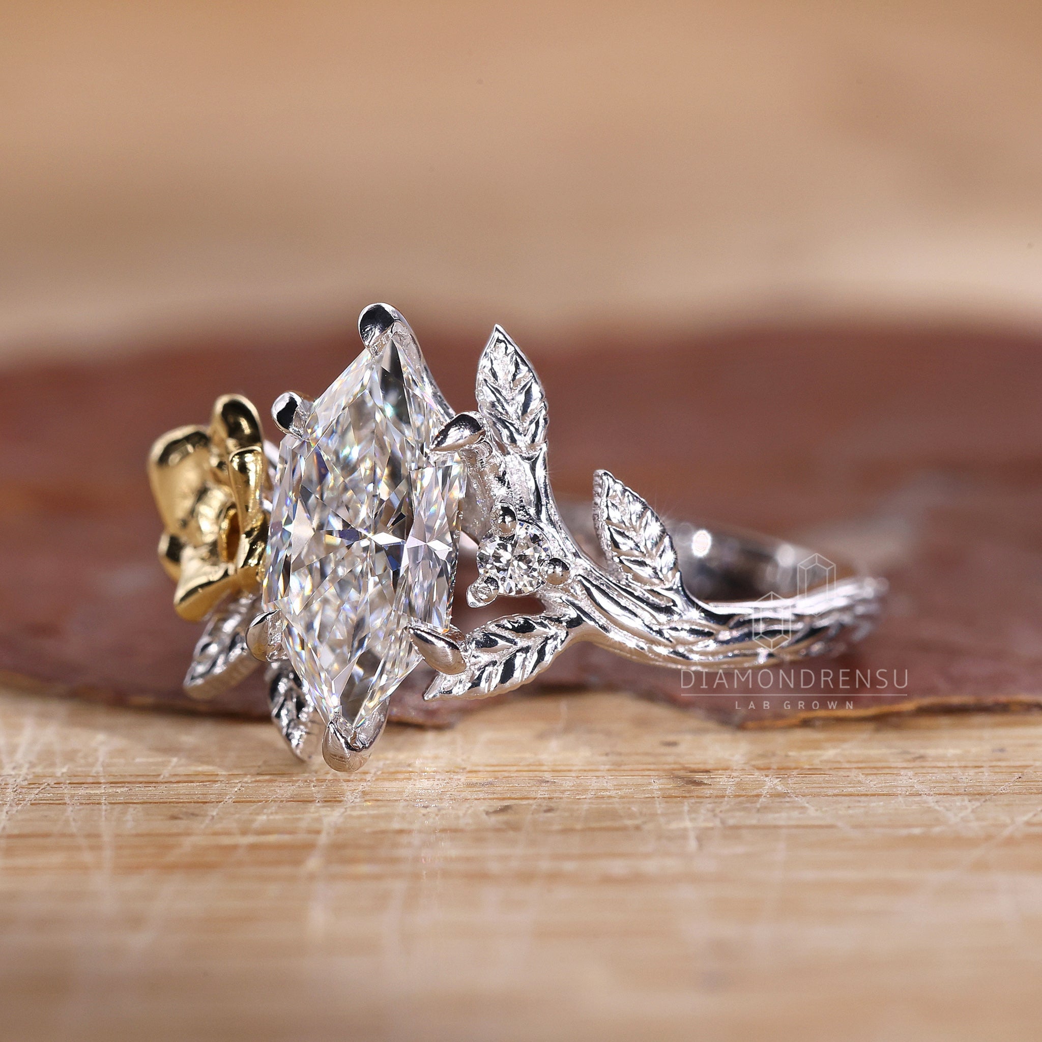 Proposal engagement ring in two tone gold with dutch marquise diamond.
