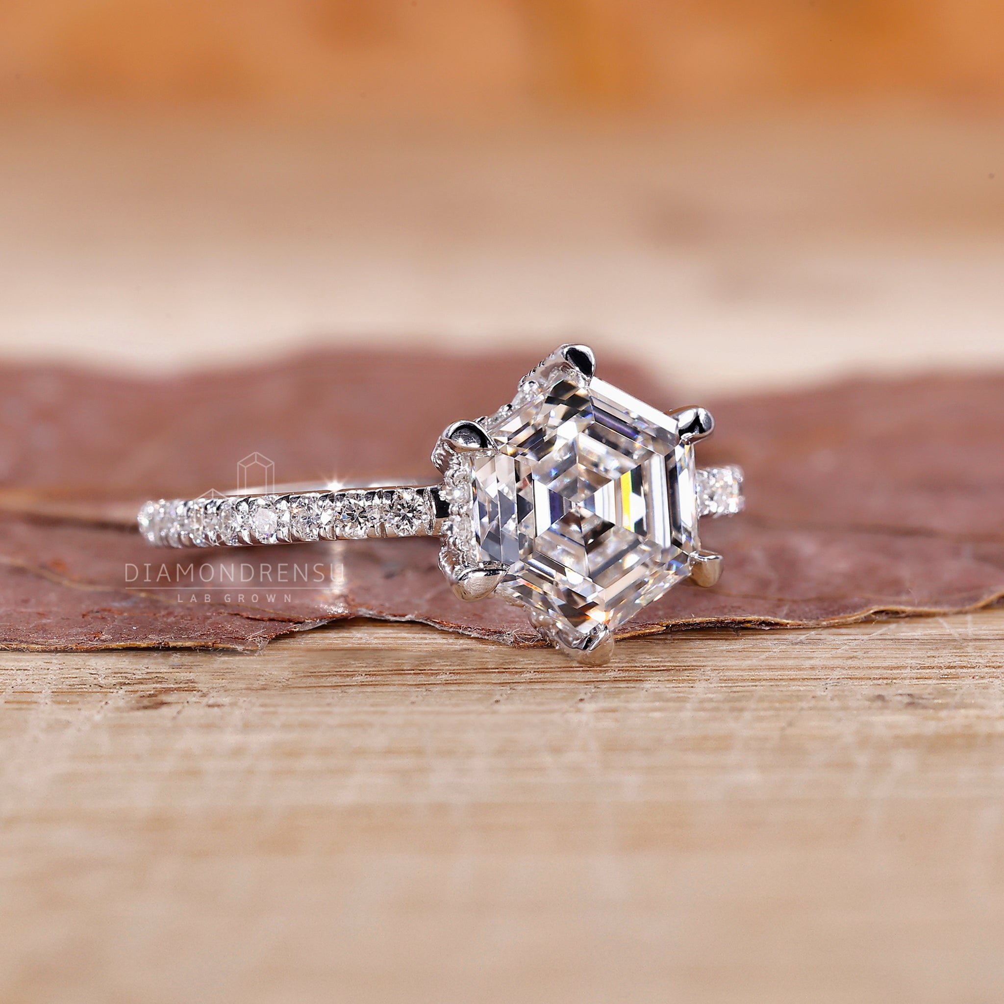 White gold engagement ring with pave setting and claw prong design.
