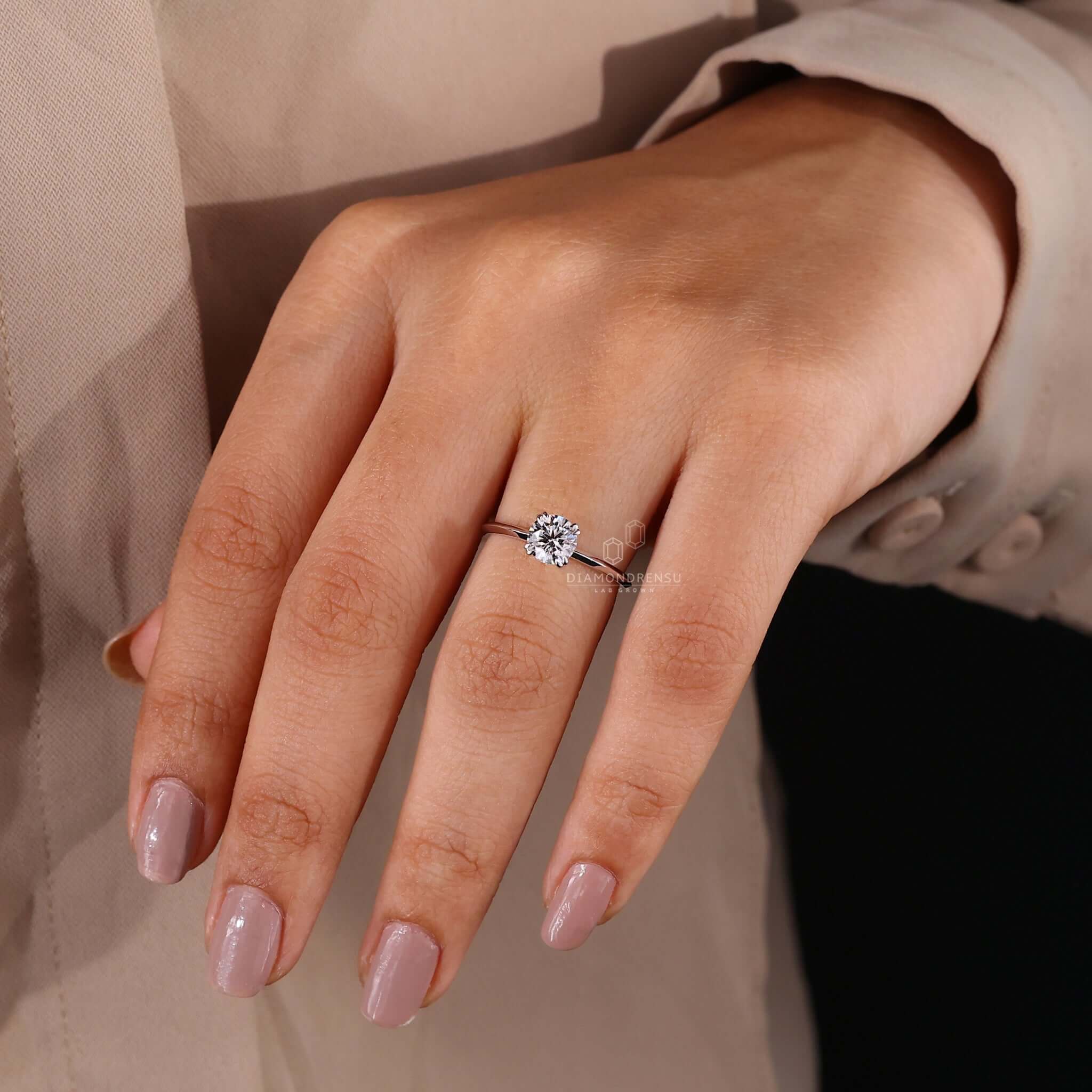 Round brilliant cut diamond ring with a unique engagement ring design in white gold.