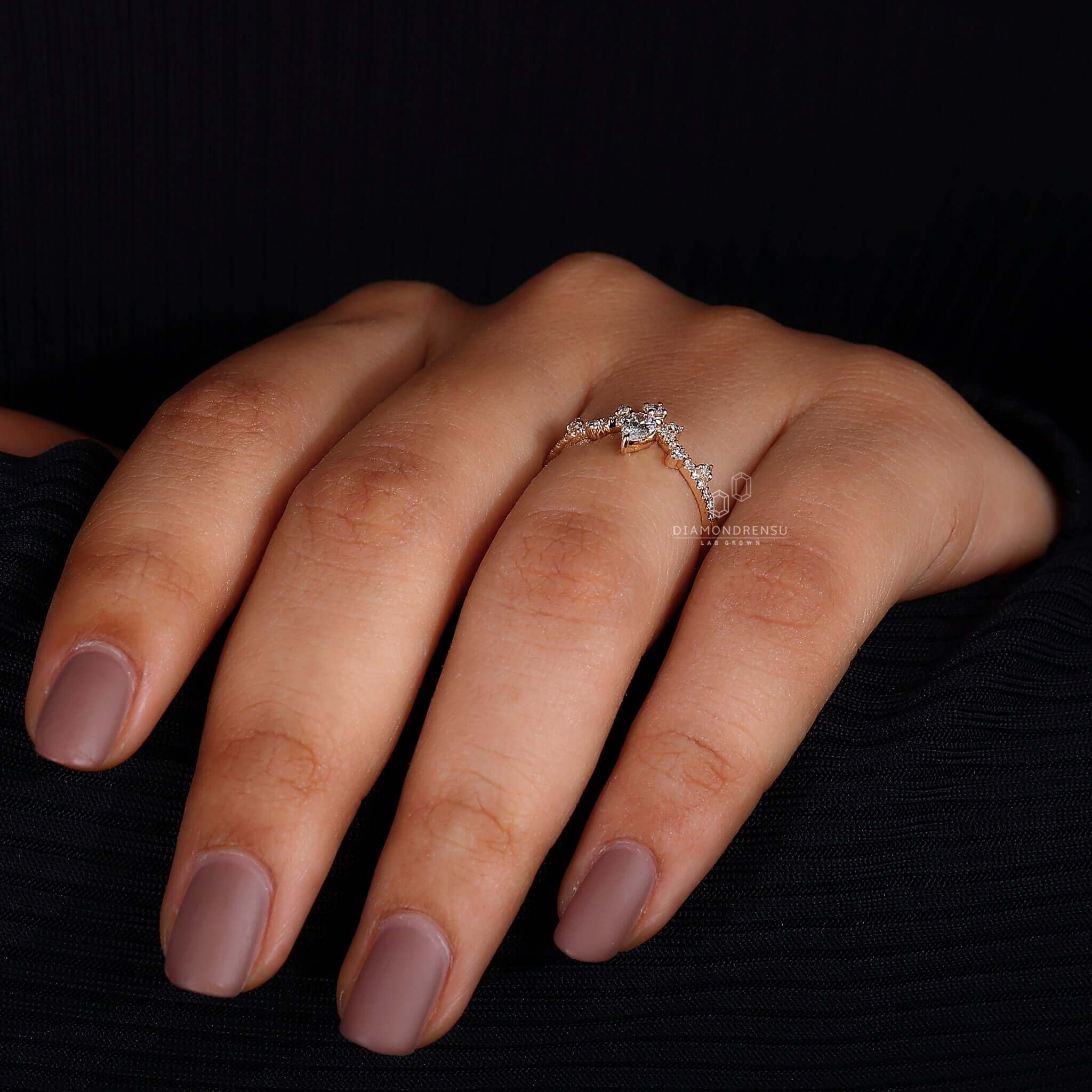 Elegant V-shaped ring showcasing a pear cut diamond in claw prongs.