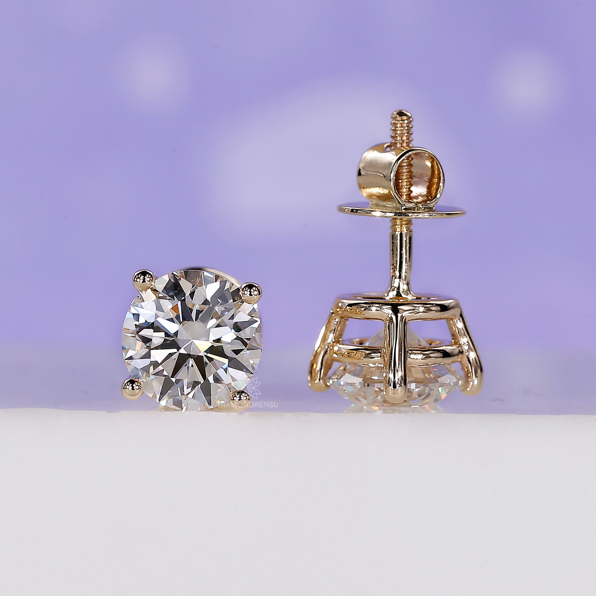 Diamond stud earrings UK made with gold and round cut diamonds.