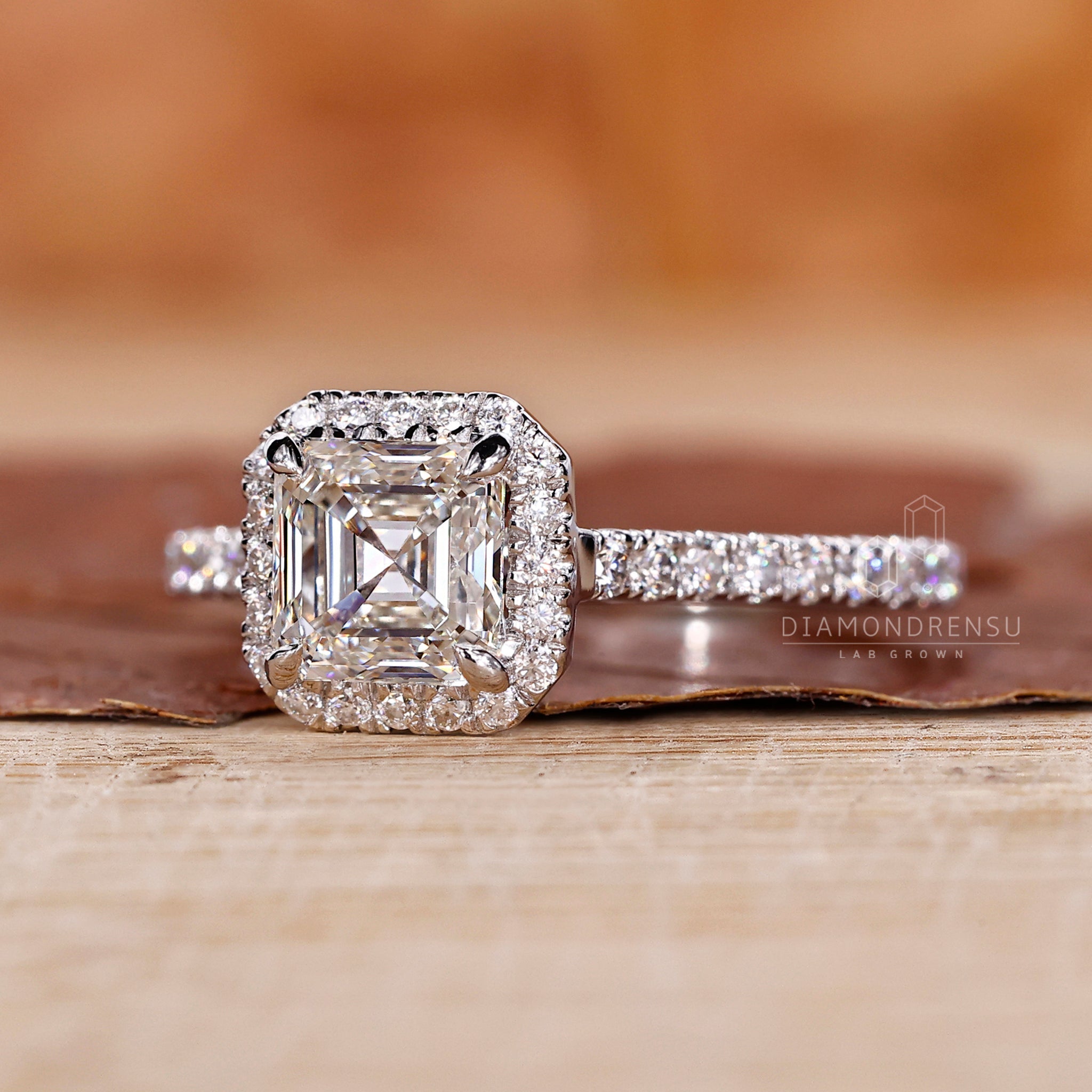 Halo ring with an asscher cut diamond and a cathedral setting, perfect as a diamond ring UK.
