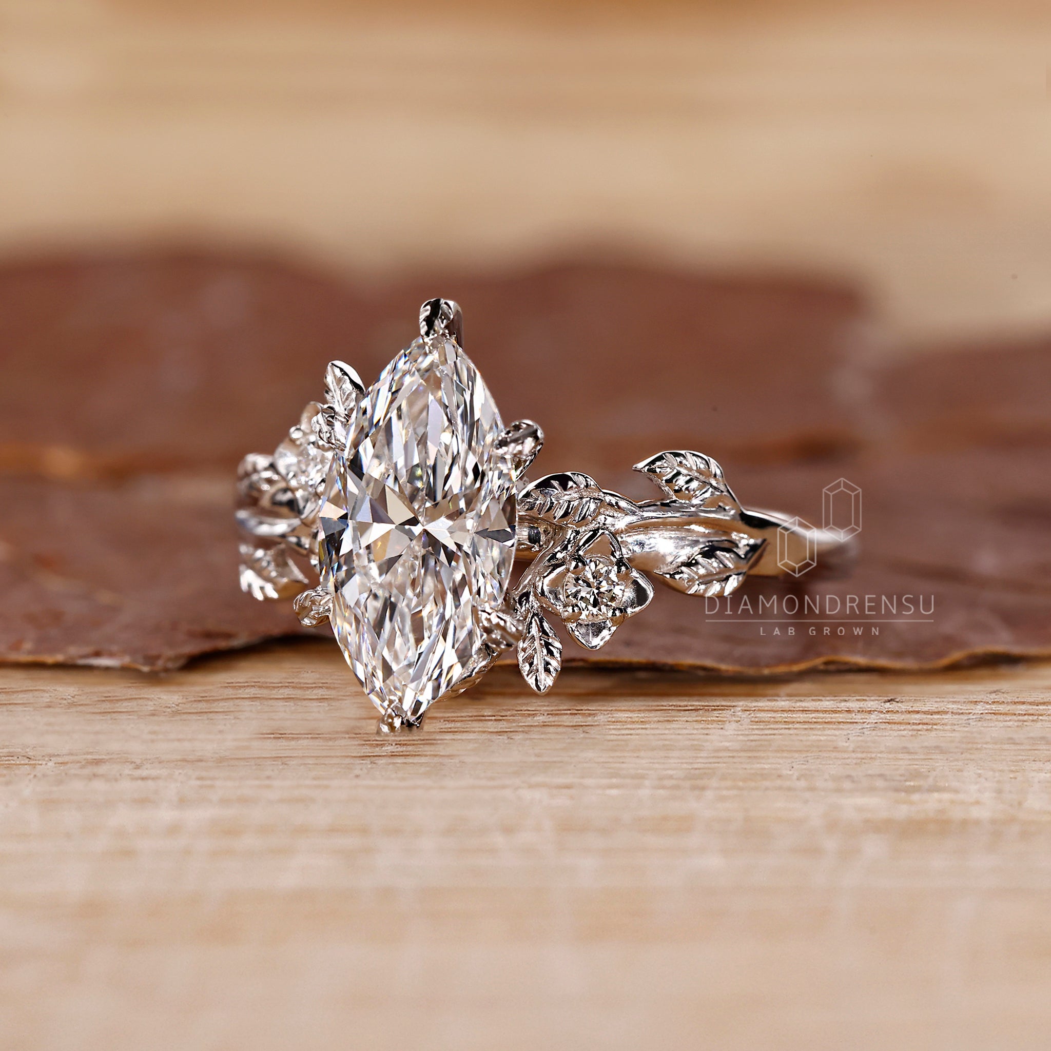 Cluster diamond ring featuring marquise and round stones.
