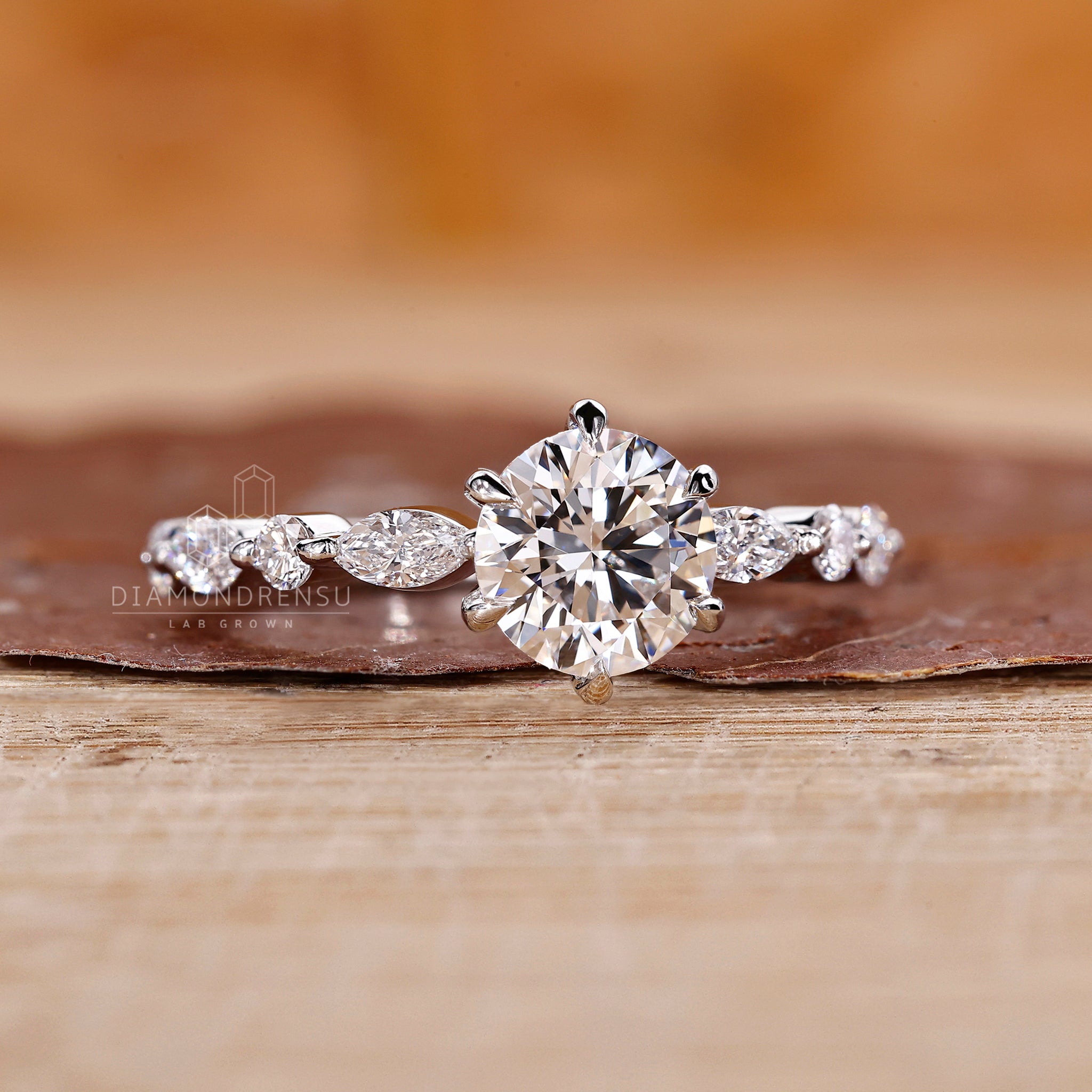 Lab grown diamond ring with white gold band and marquise side stones.
