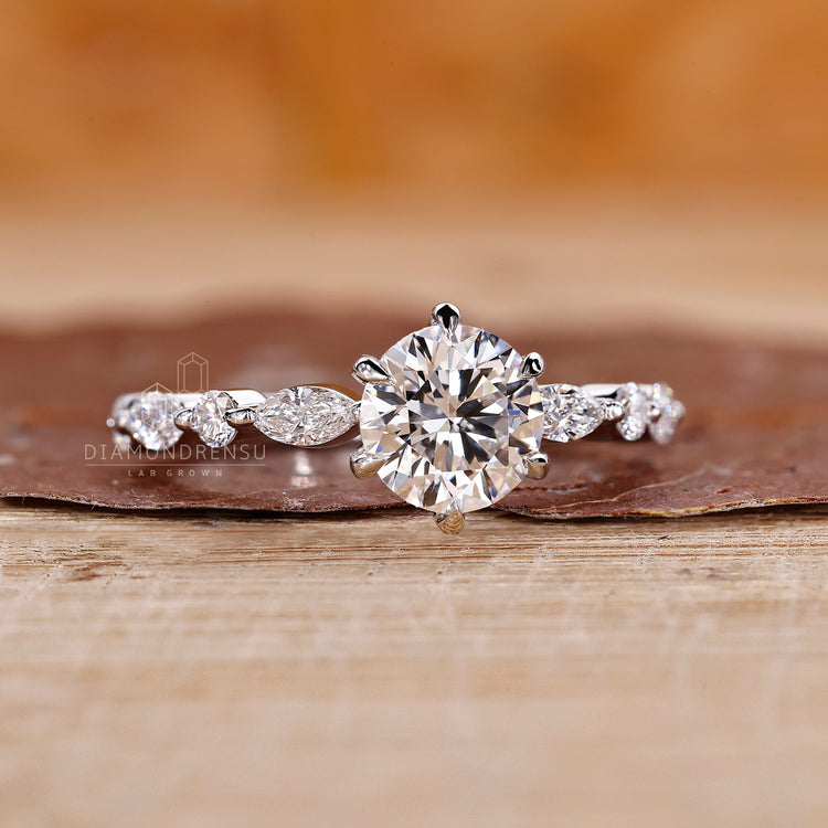 Lab grown diamond ring with white gold band and marquise side stones.
