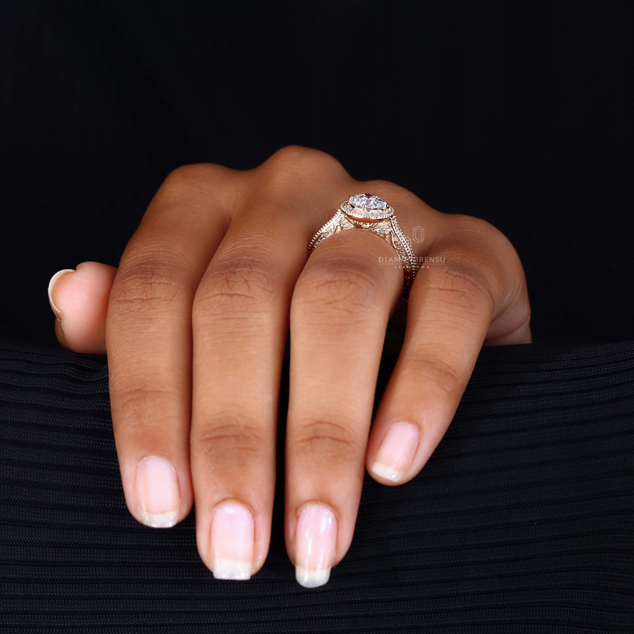 A luxurious filigree ring with gold detailing and a stunning central diamond.