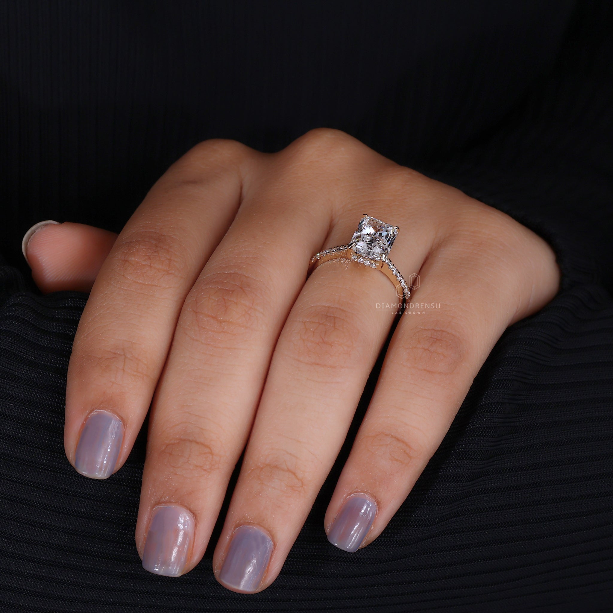 Handmade radiant cut engagement ring on model, featuring lab-grown diamond and pave diamonds in a yellow gold setting