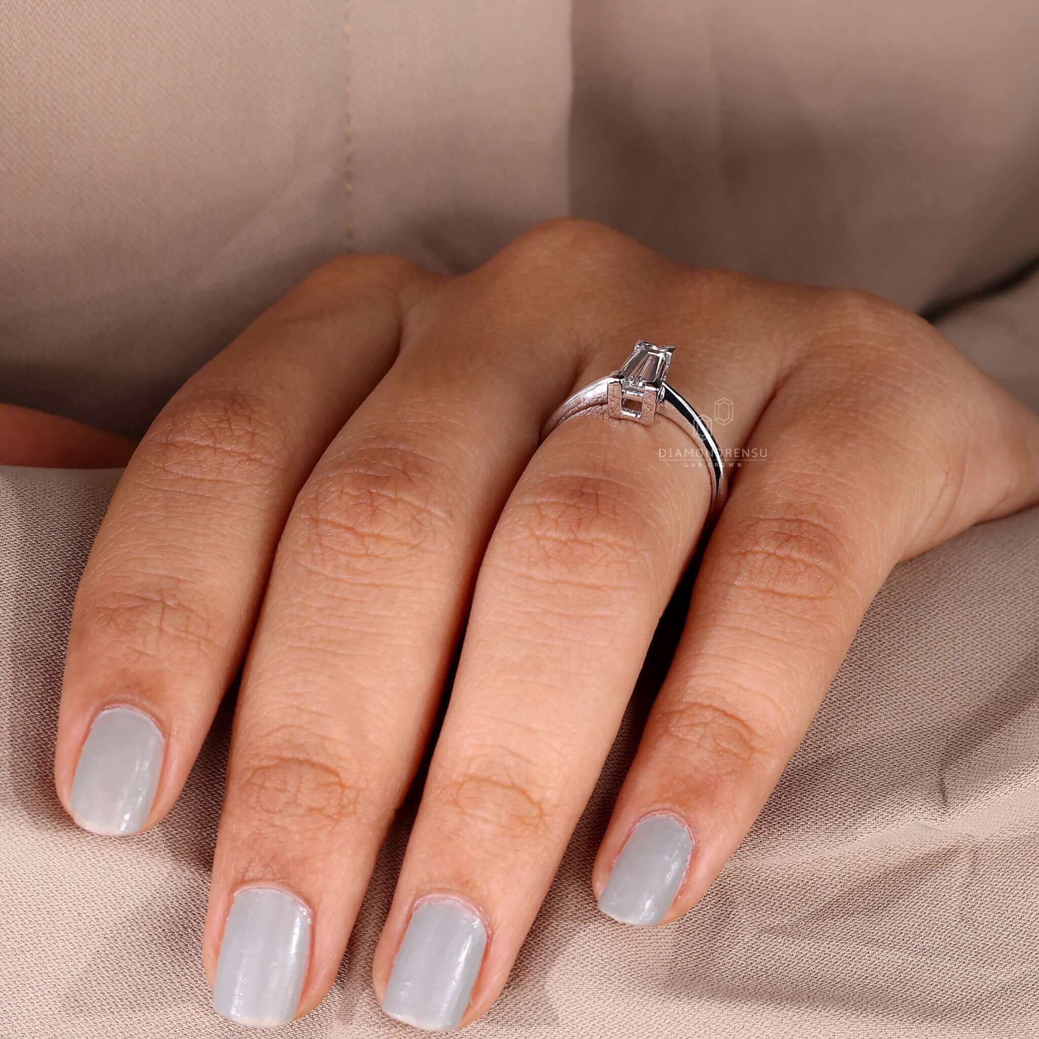 Baguette diamond ring featuring a solitaire diamond in a v prong setting