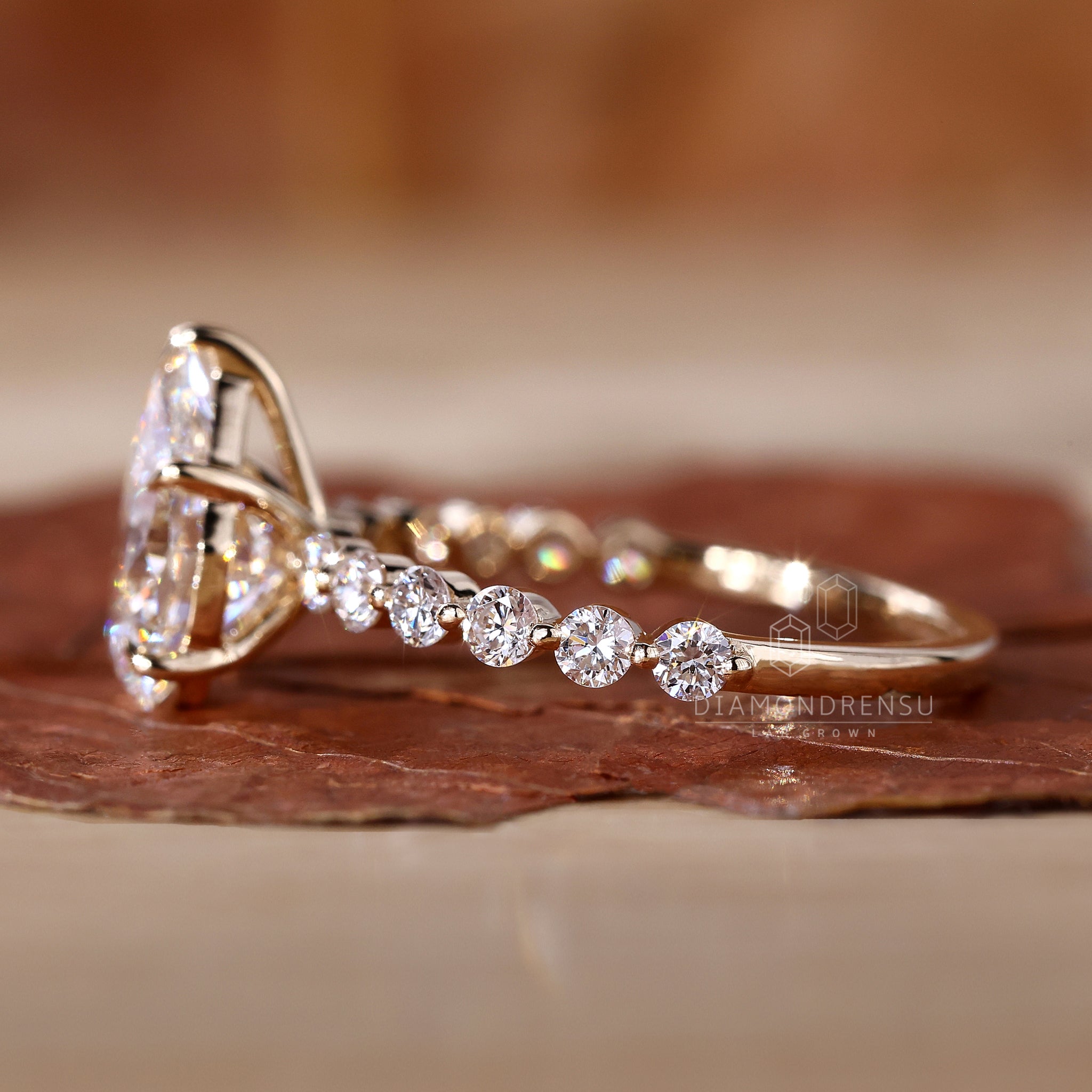 Non-traditional engagement ring with a modern spear cut diamond in gold.