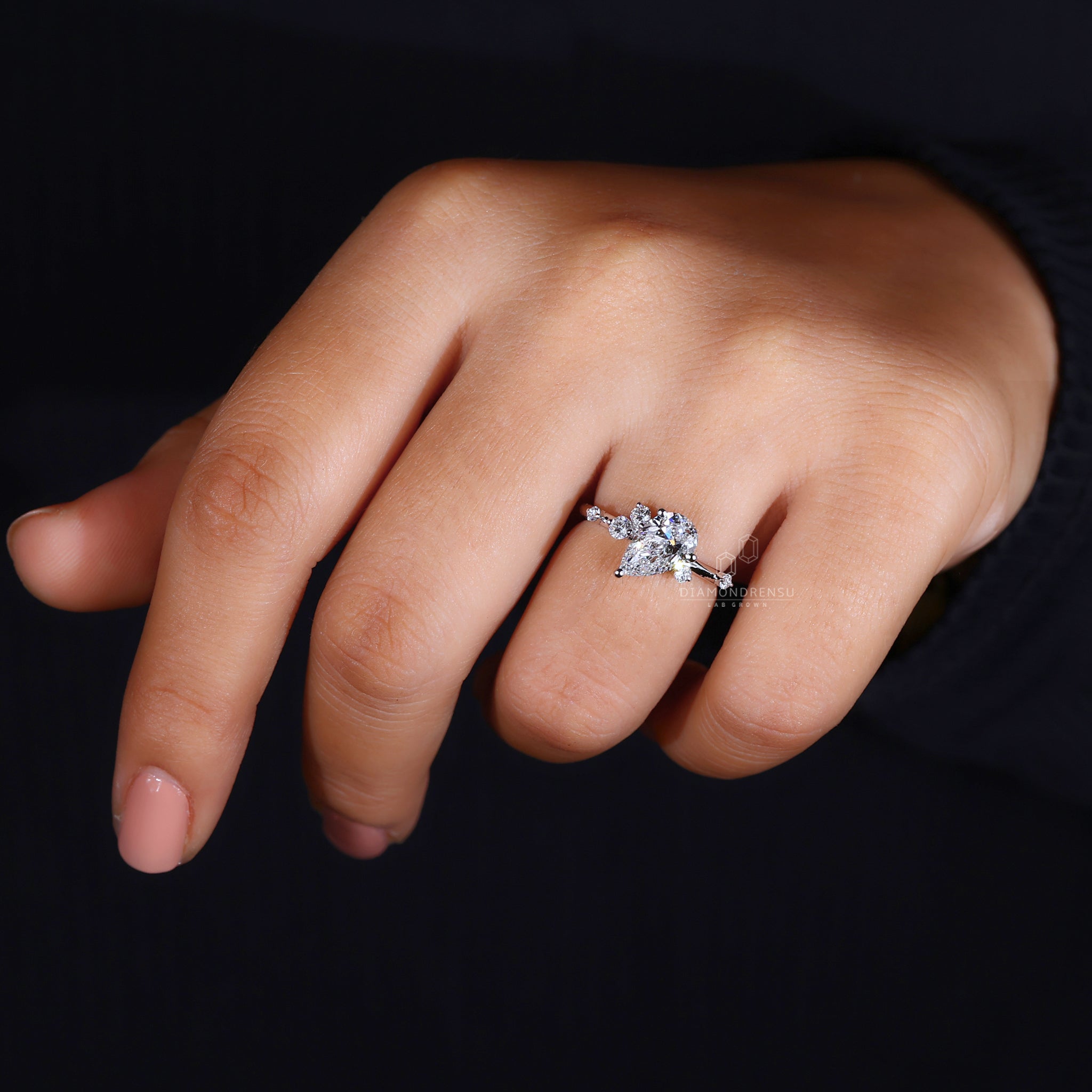 White gold engagement ring with a pear-shaped centre diamond.