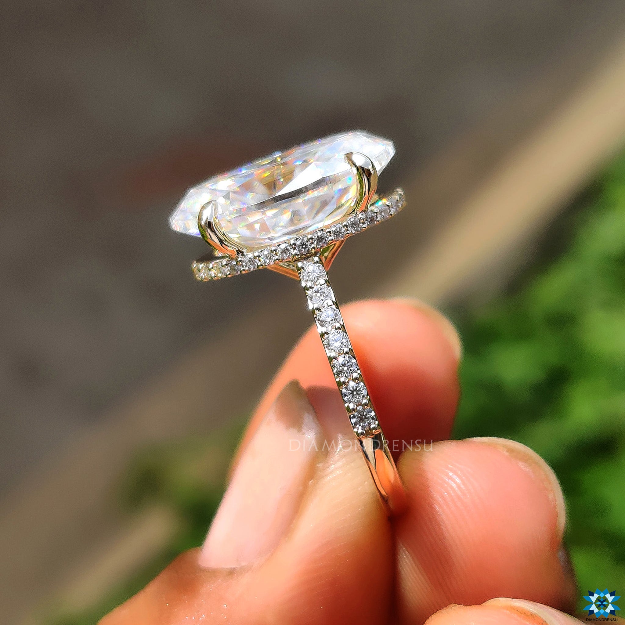 Diamondrensu UK engagement ring featuring oval cut moissanite with pave round band.
