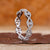Twisted wedding band with round lab grown diamonds.
