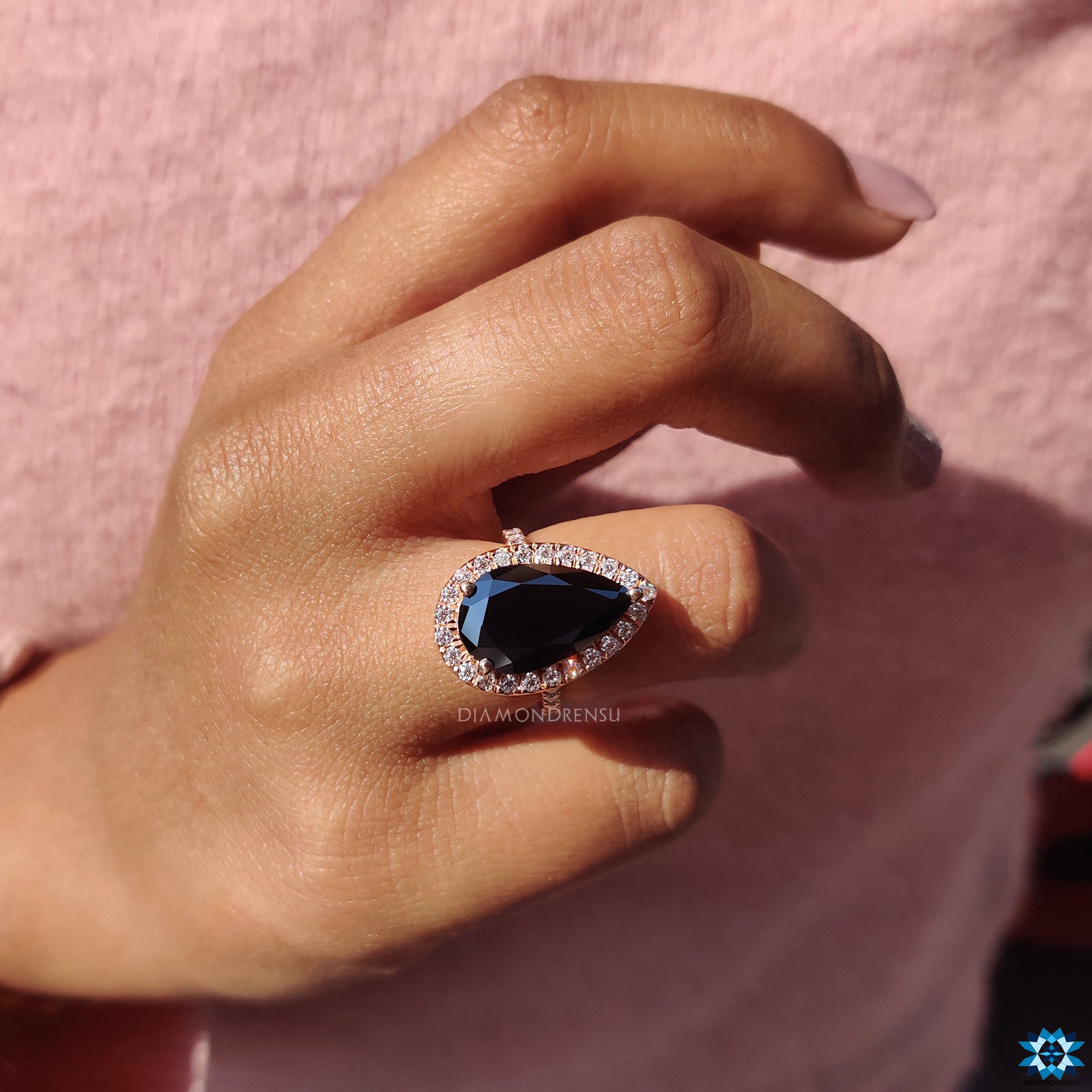 Buy UK engagement ring featuring black moissanite and round pave stones.
