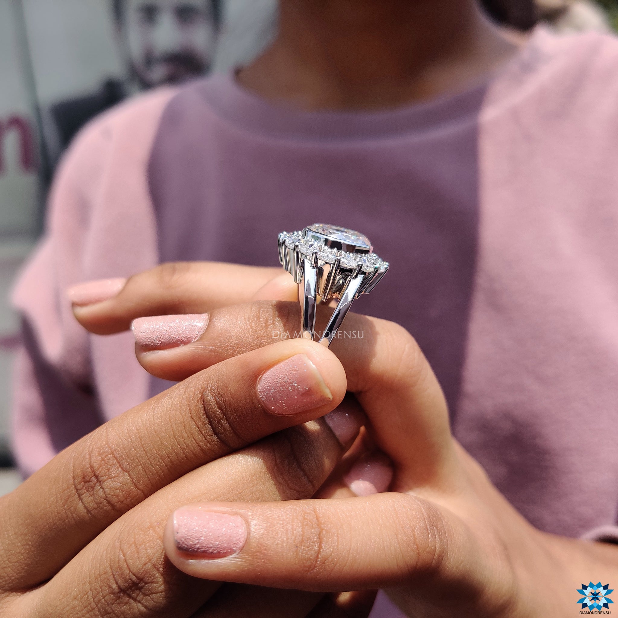 Bezel halo setting enhances the brilliance of Portuguese cut moissanite.
