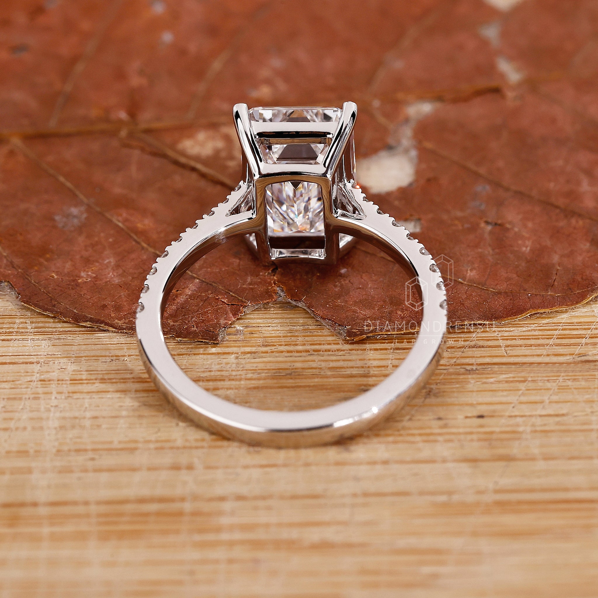 Custom engagement ring with emerald cut diamond.
