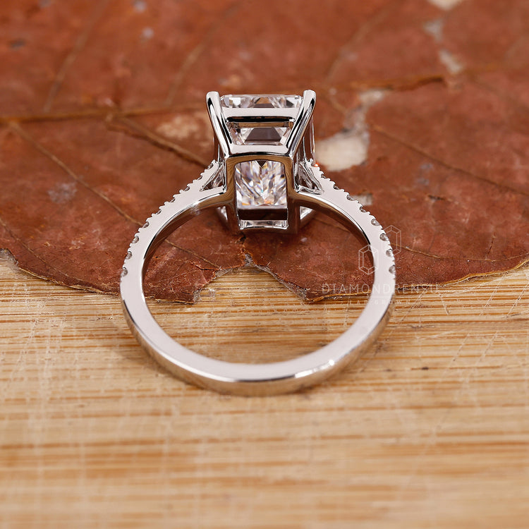 Custom engagement ring with emerald cut diamond.
