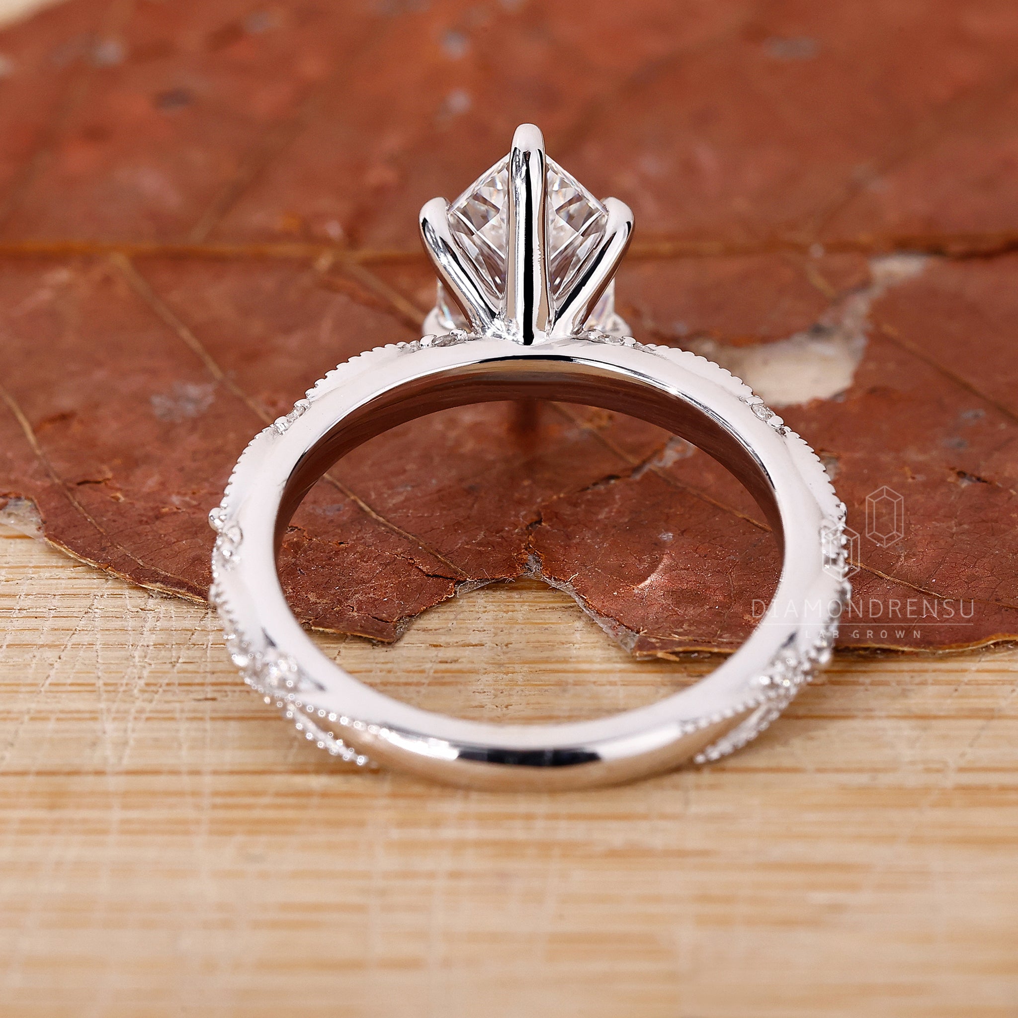 Buy engagement ring with marquise and round side stones.
