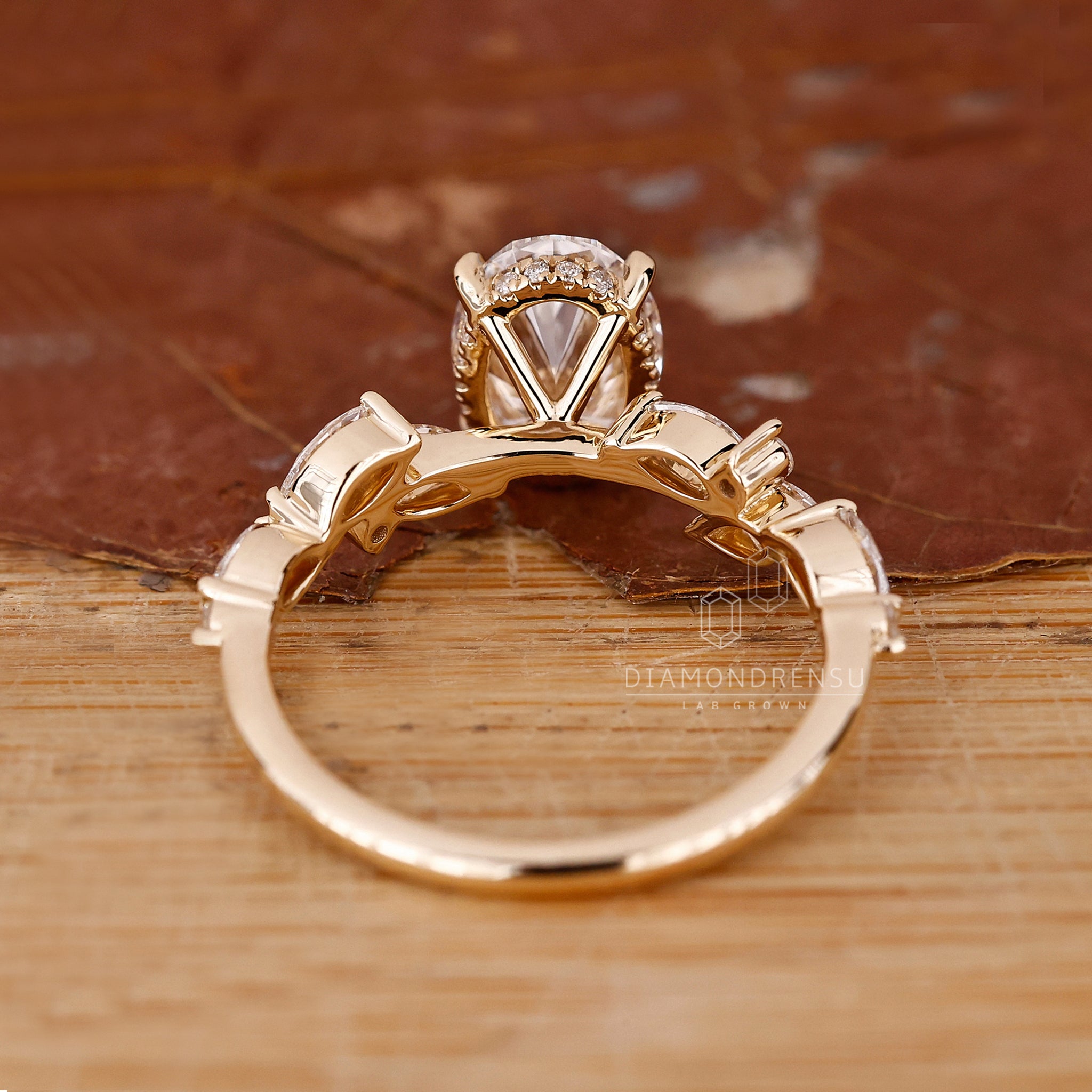 Round diamond side stones with halo oval ring engagement
