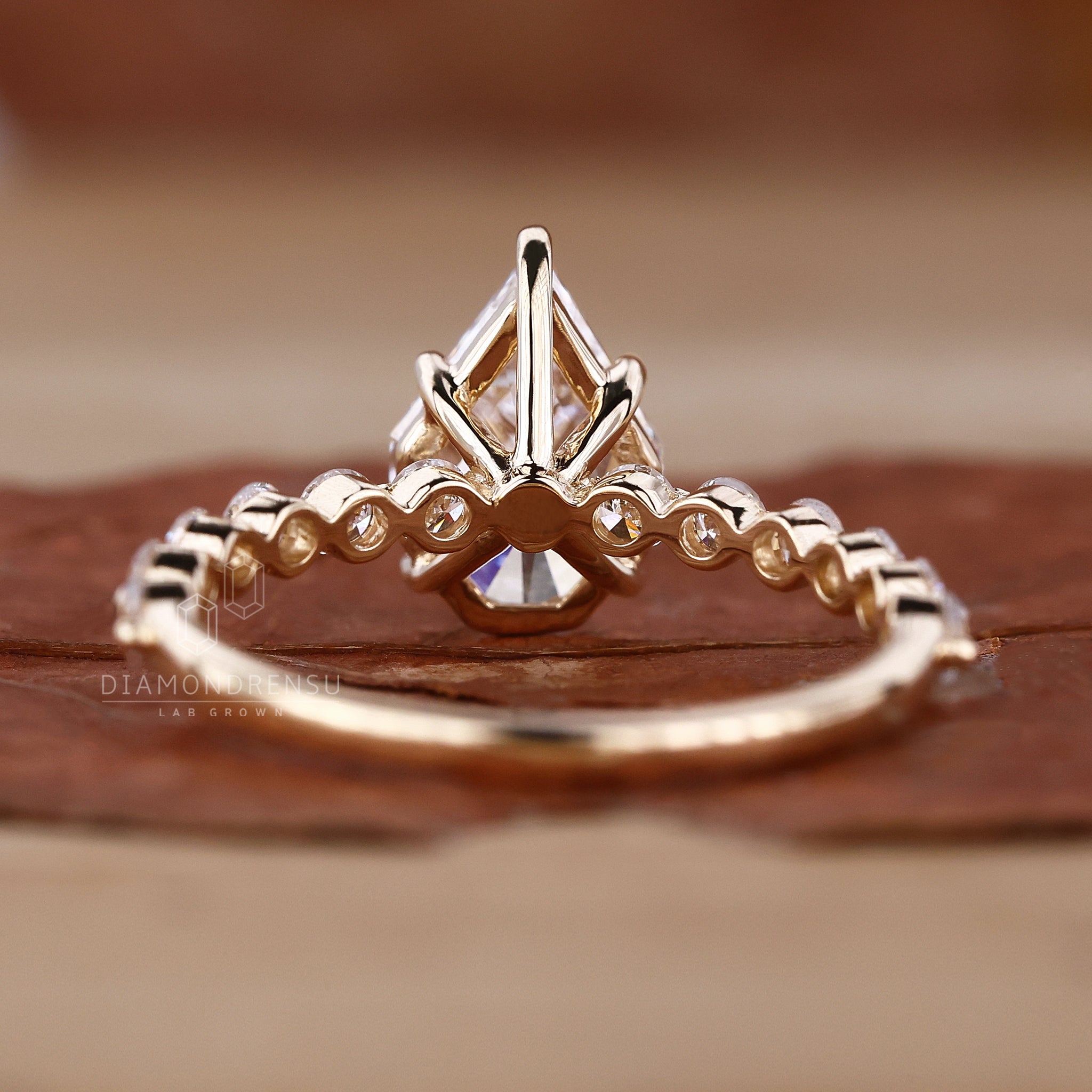 Shared prong engagement ring in elegant yellow gold.