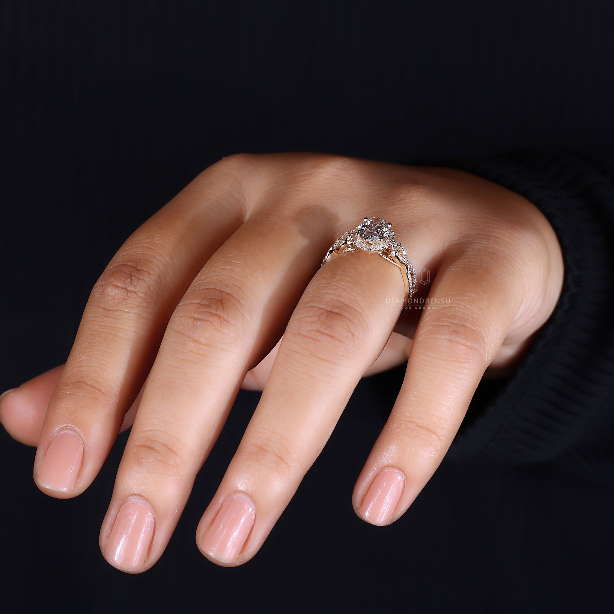Round cut halo setting with side diamonds.
