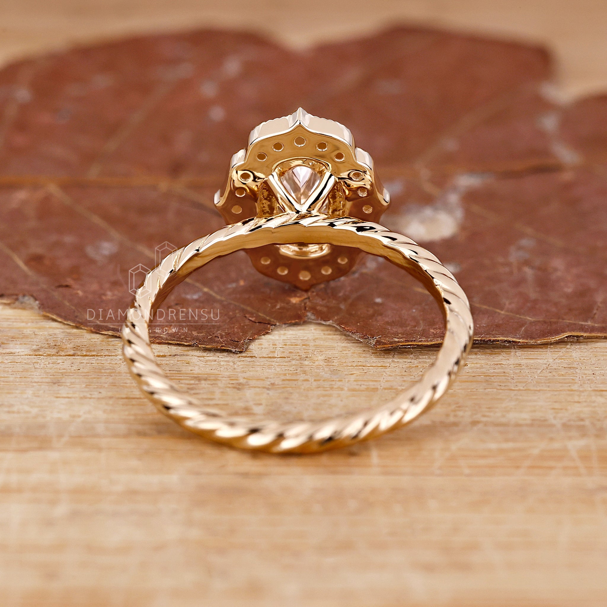 Yellow gold ring pairs with oval and halo design for an attractive finish.
