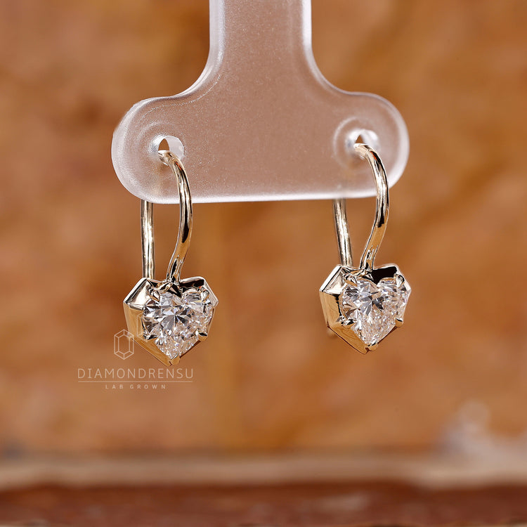 Bezel set heart diamond earrings.