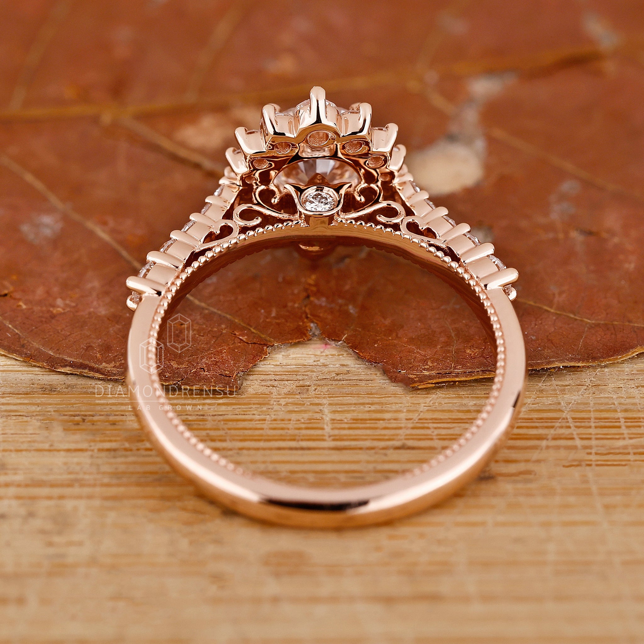 Filigree engagement ring featuring a round cut diamond.
