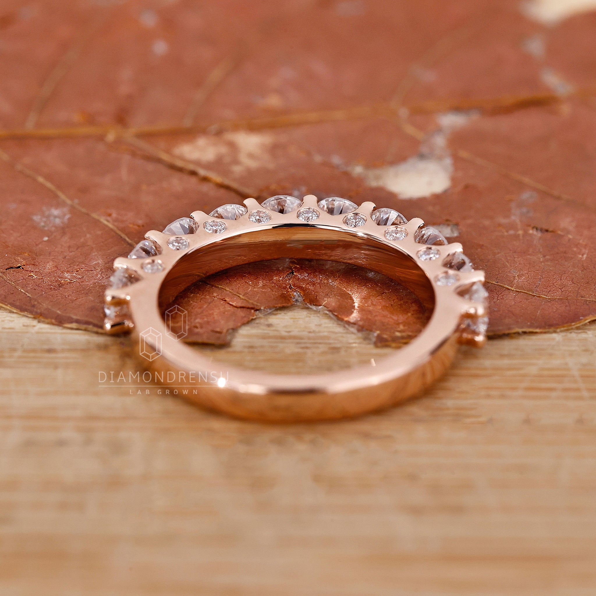 Rose gold wedding band with half eternity design
