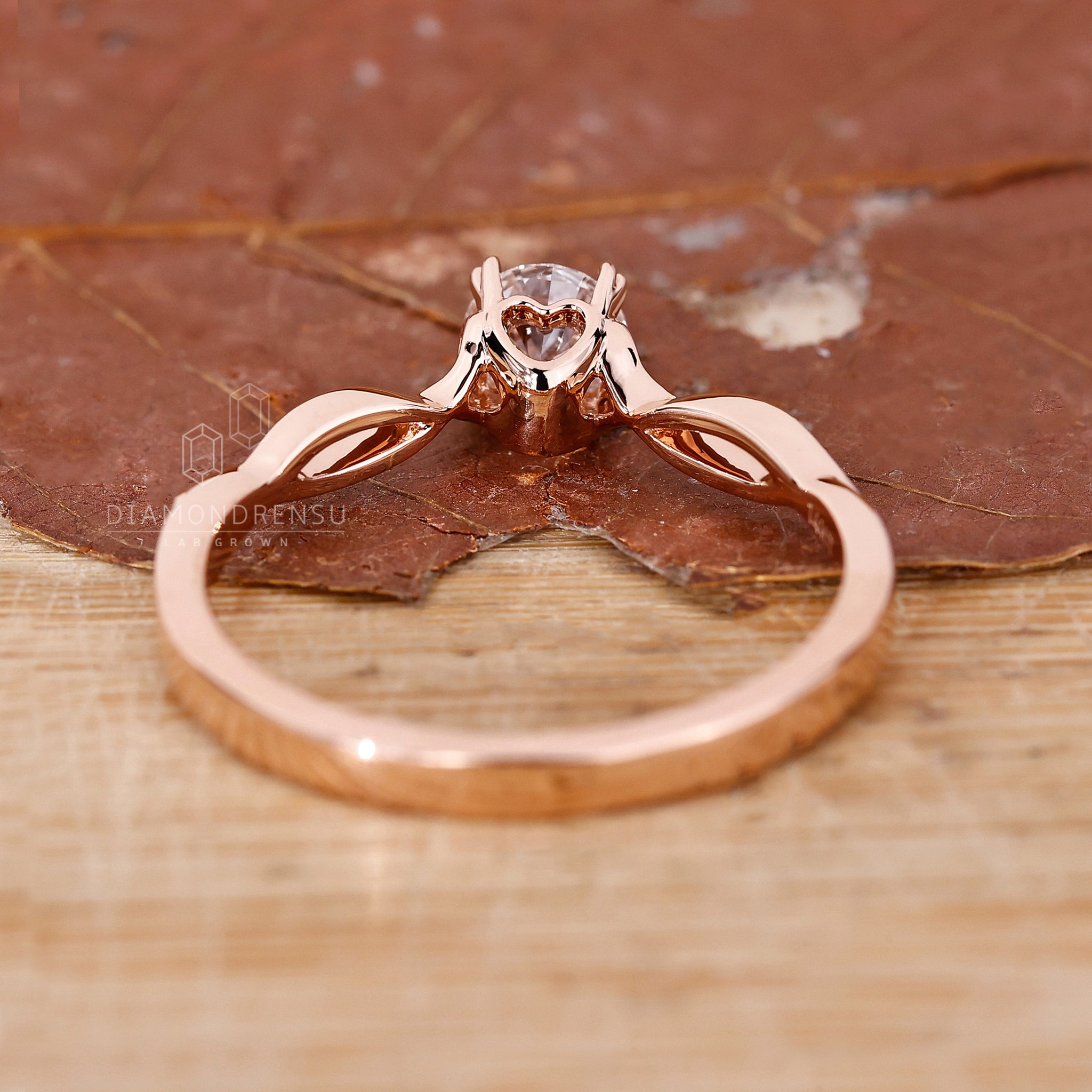 Proposal engagement ring with solitaire diamond and hart shape prong set.

