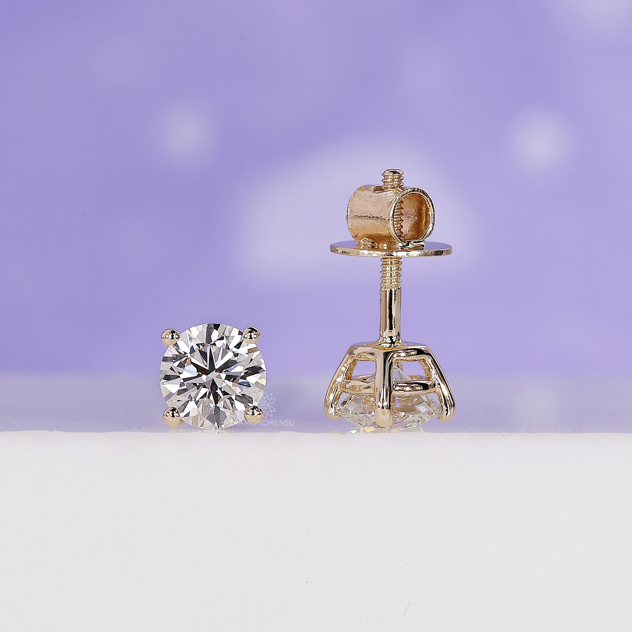 Handmade jewellery showcasing yellow gold round diamond stud earrings.
