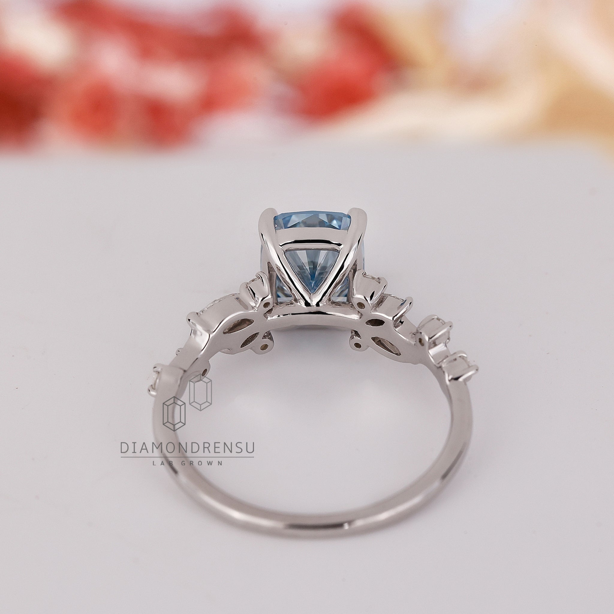 Lab grown blue diamond ring with 4 prong claw setting.

