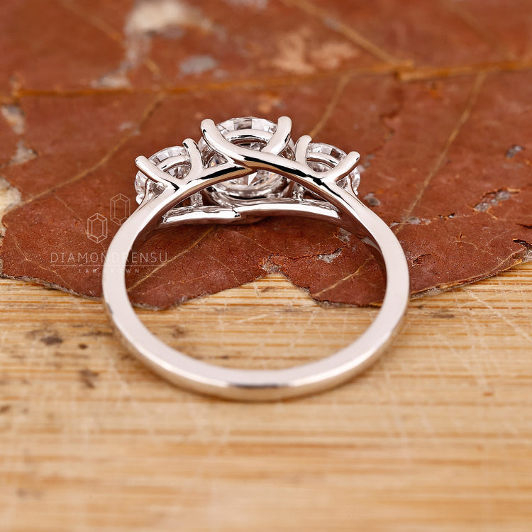 Handmade jewellery ring featuring trellis setting and round diamonds.
