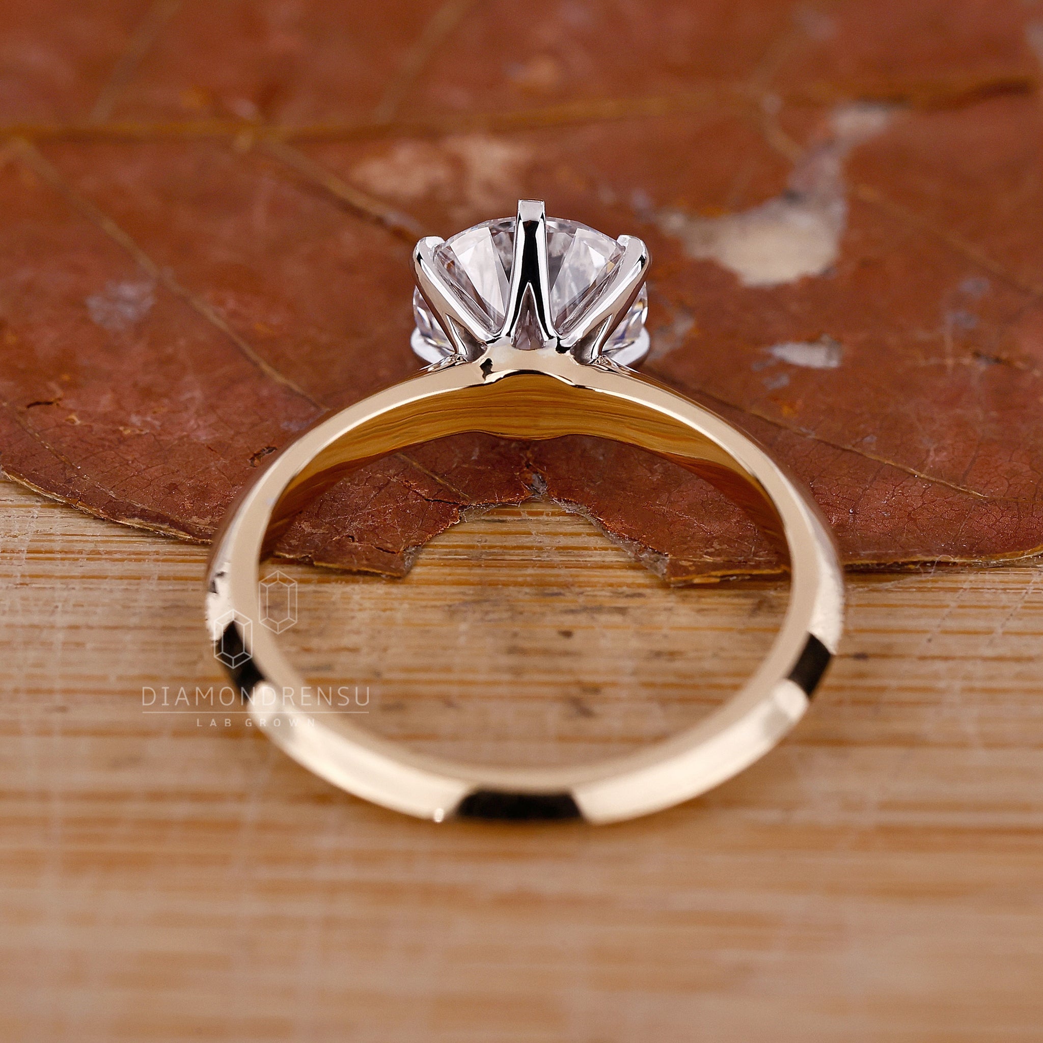 Lab grown diamond ring with round cut stone and knife edge design.
