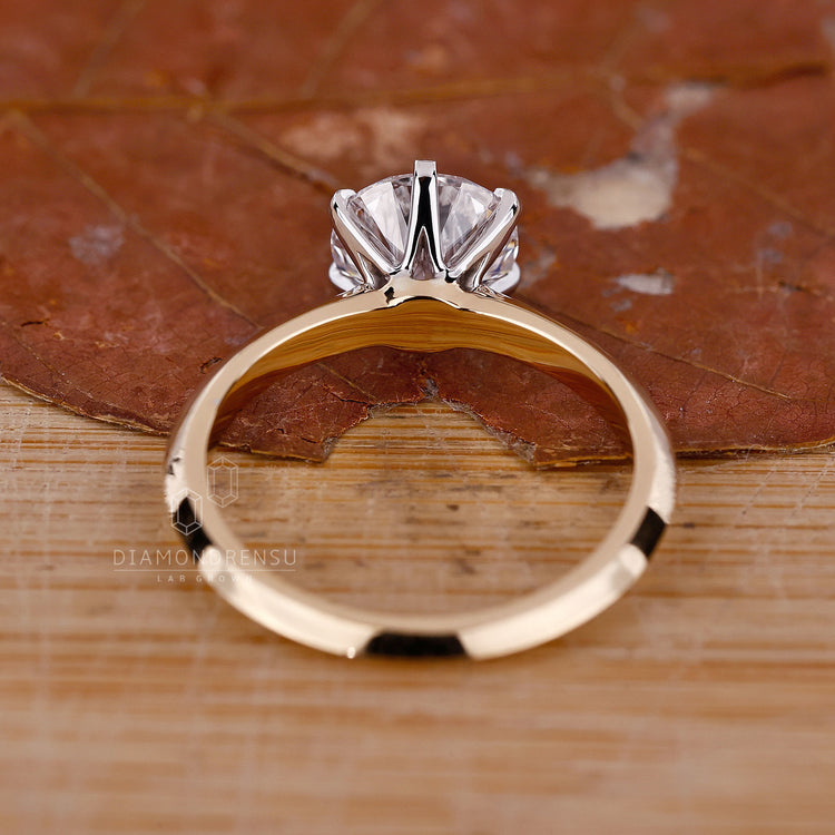 Lab grown diamond ring with round cut stone and knife edge design.
