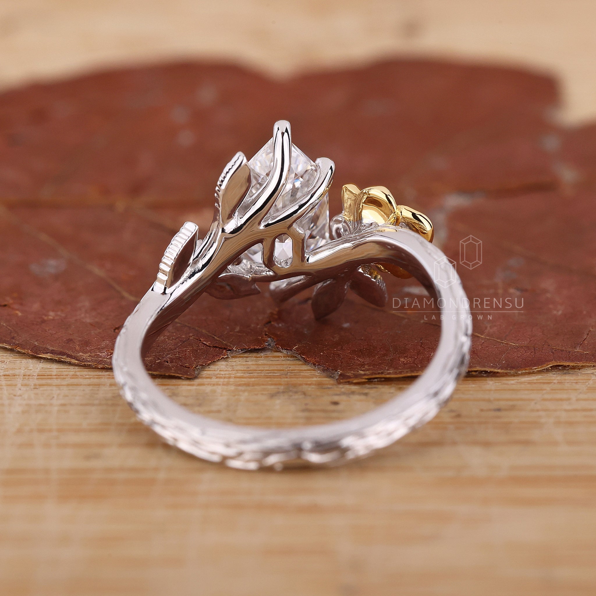 White and yellow gold diamond ring with nature inspired setting.
