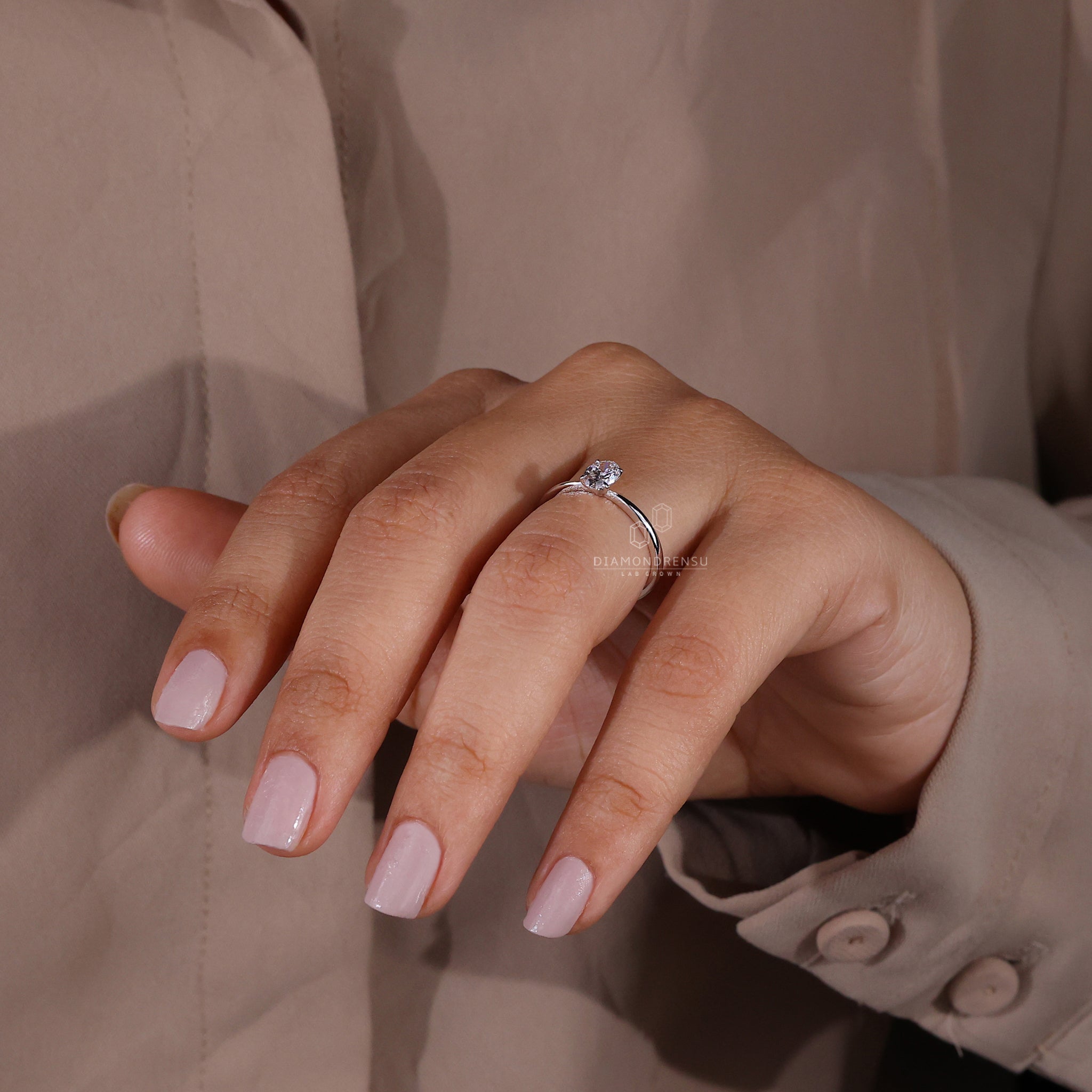 White gold engagement ring with oval diamond.
