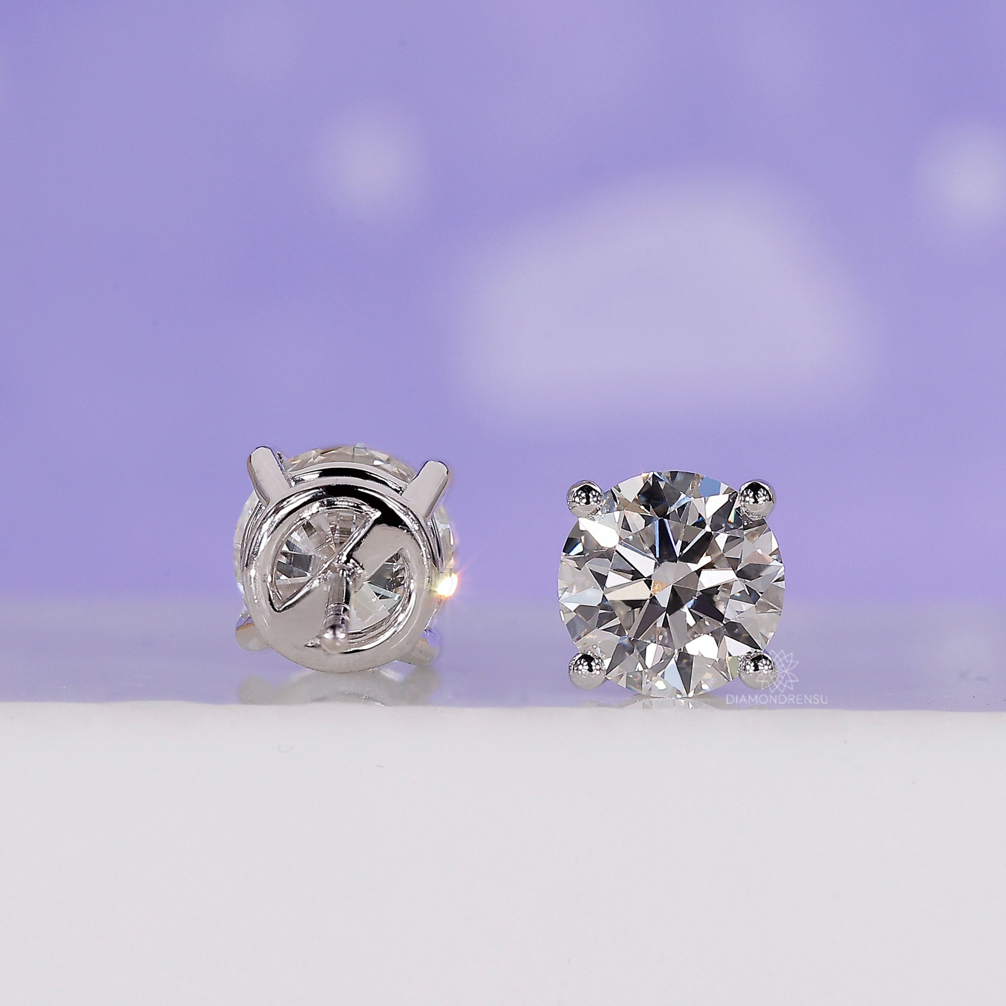Round diamond stud earrings with handmade gold setting and fine polish.
