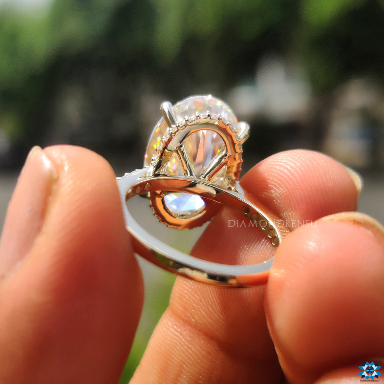 Buy engagement ring with large 7.70 carat oval moissanite and hidden halo sparkle.
