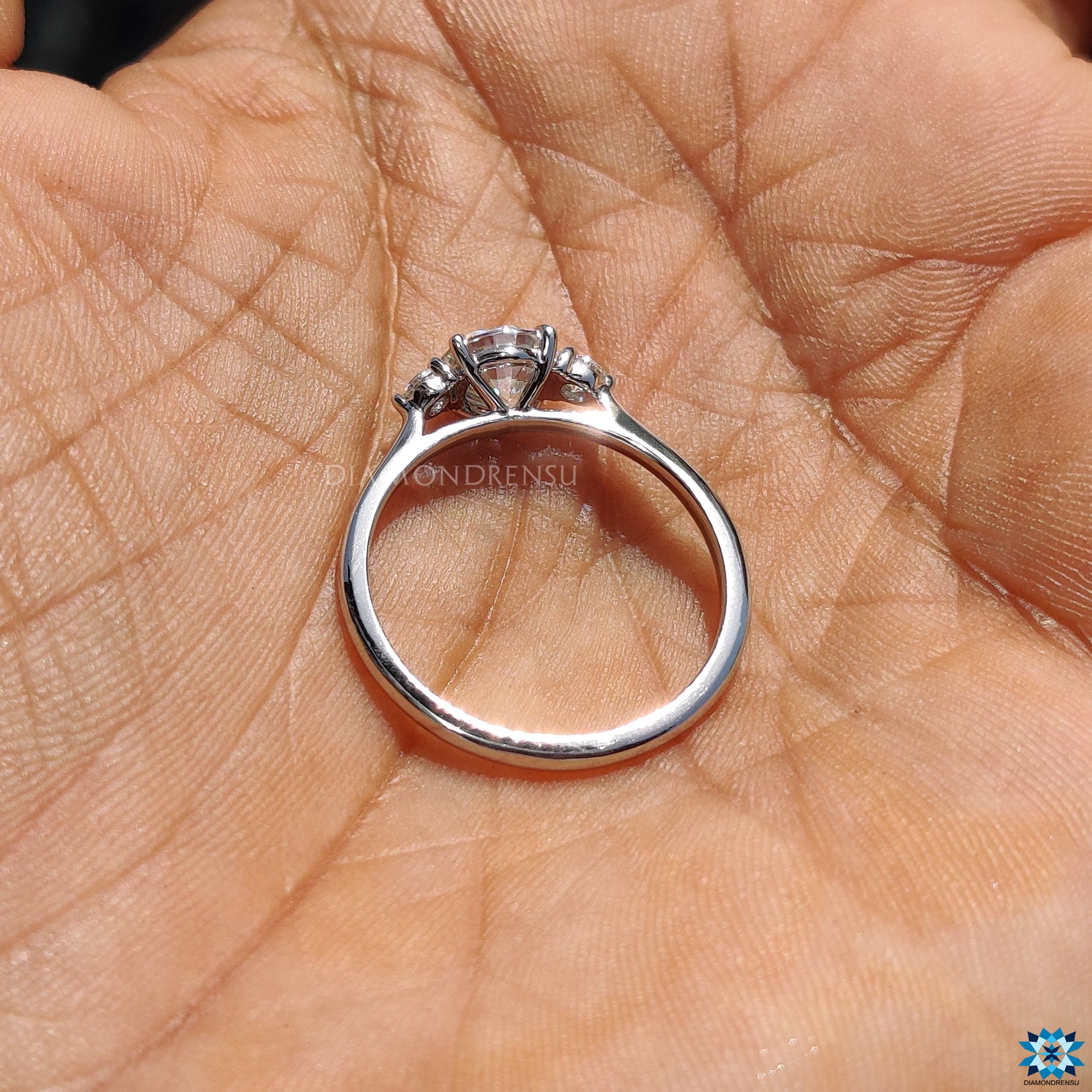 Moissanite for engagement ring in triple stone white gold setting.
