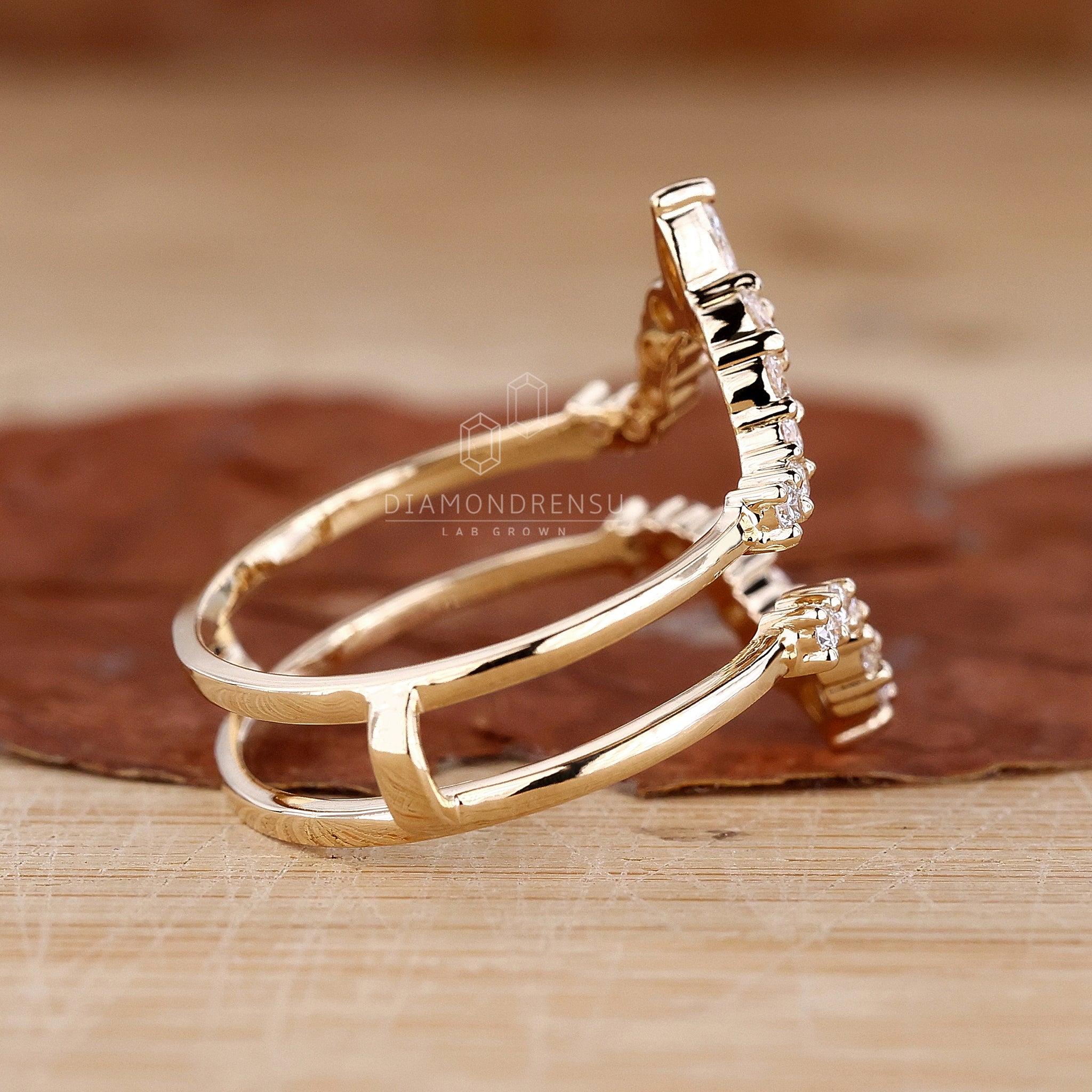 Curved guard band with round and marquise diamonds.
