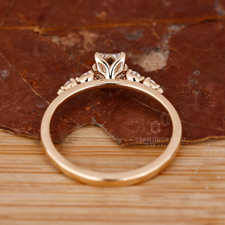 Buy engagement ring with emerald and round diamonds.
