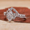 Vintage engagement ring in white gold bridal set with curved wedding band.
