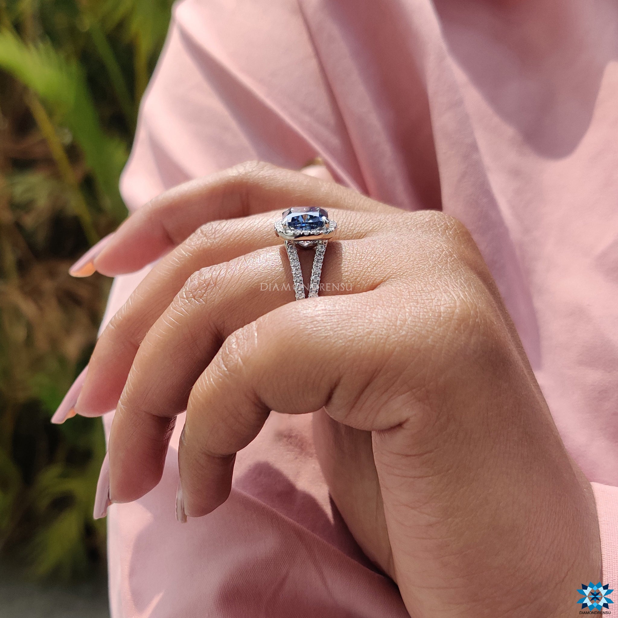 Halo cushion moissanite ring with handcrafted pave split shank and white gold finish.
