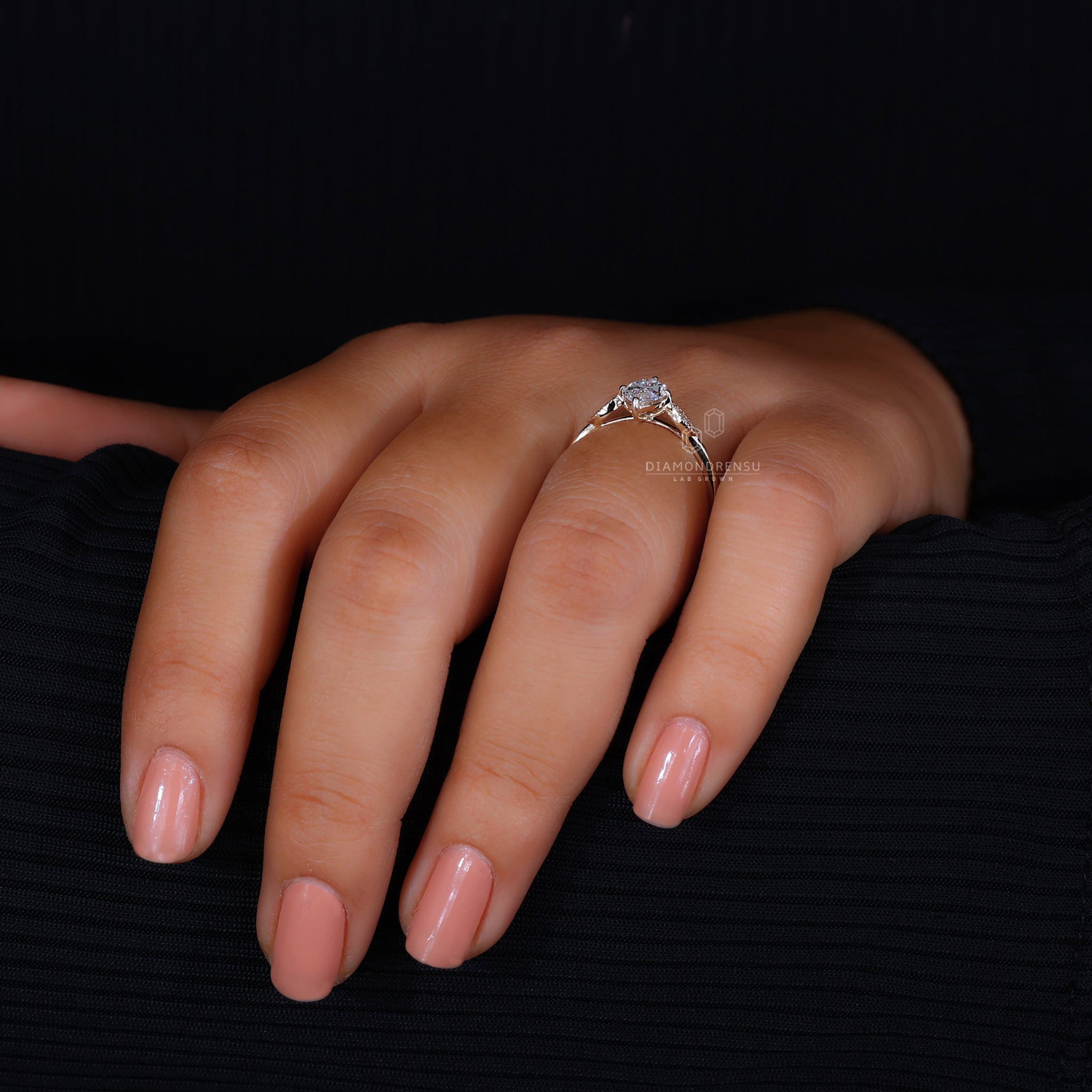 Round diamond side stone with marquise center.
