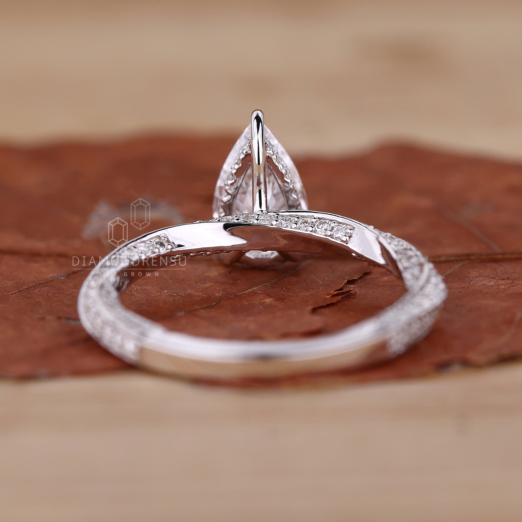 Hidden halo ring showcasing a brilliant pear cut diamond.