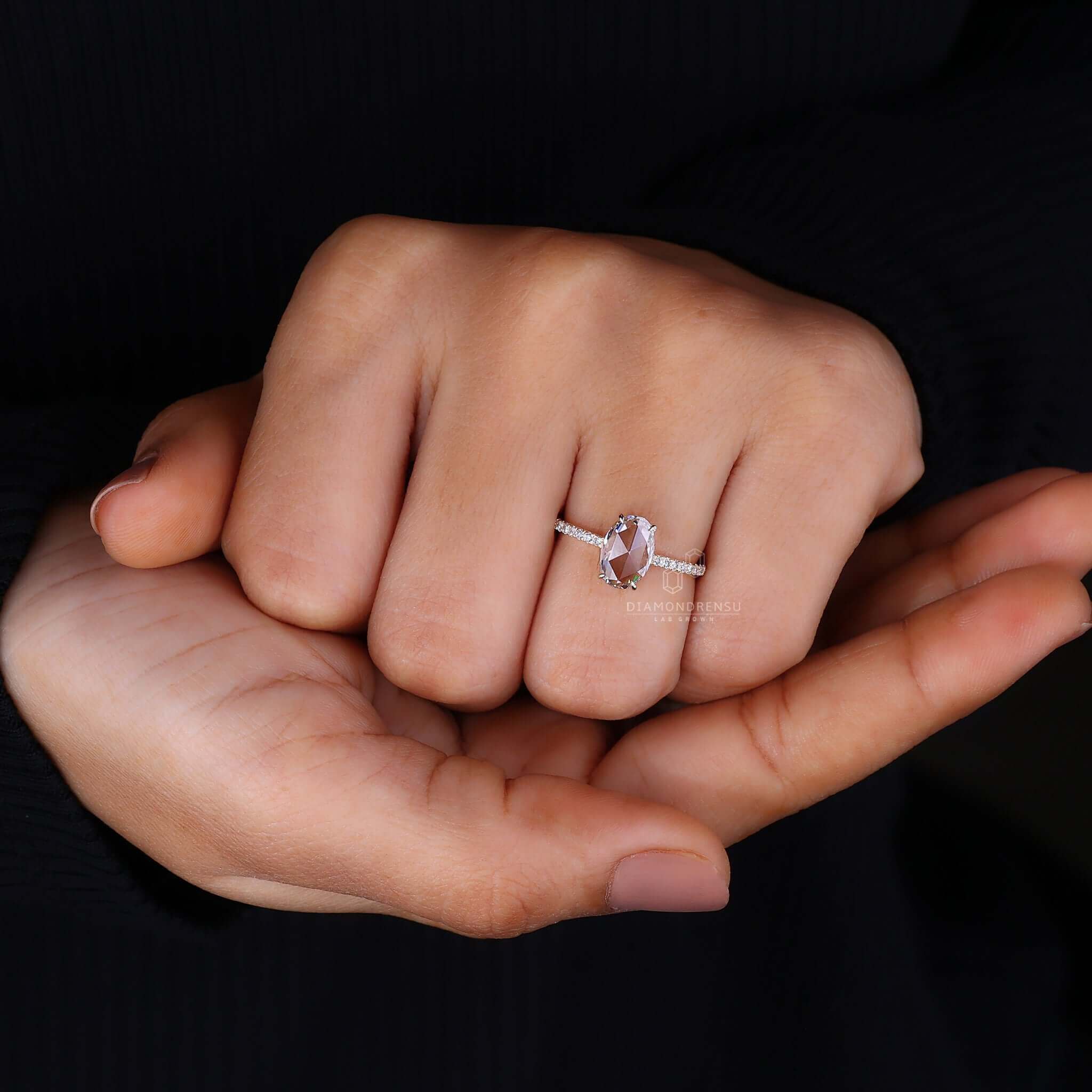 Oval cut pave engagement ring with brilliant diamond accents.