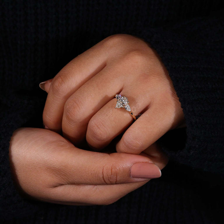 Two Side Stones pear diamond engagement ring in claw prong setting.